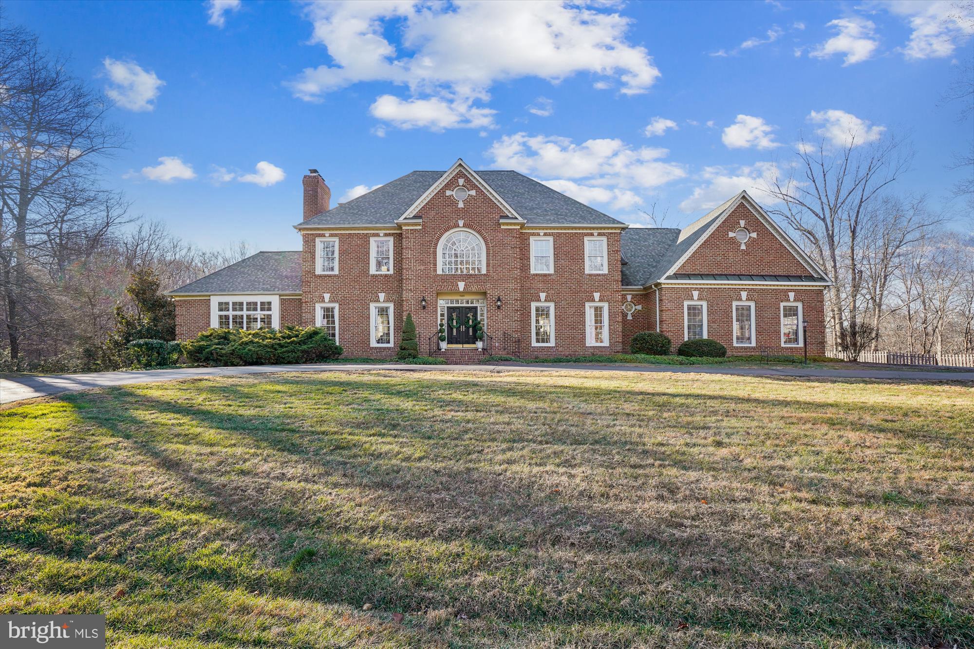 Update: Multiple offers are anticipated.  Please submit offers by 5pm, Monday  1/12. 
Tucked away on a quiet cul-de-sac, this timeless brick colonial offers a rare blend of privacy and community on approximately 6.5 acres in Clifton, one of Northern Virginia’s most coveted neighborhoods. Surrounded by mature woods, the backyard features a private fishing pond with a fountain, an expansive deck and in-ground pool, perfect for entertaining.  Peaceful views abound in every direction—yet it’s less than five minutes from Main Street Clifton, Paradise Springs Winery, and Hemlock Overlook Regional Park.
Inside, the home offers four bedrooms and four-and-a-half baths with thoughtful updates throughout. Upstairs bathrooms are completely renovated, and the kitchen gleams with refreshed cabinets and brand new appliances. Hardwood floors span the main living areas, complemented by fresh interior paint and new light fixtures throughout. Five fireplaces add warmth and elegance to every level. The large main-level office provides an ideal work-from-home retreat. A four-car garage completes the package, providing ample space for vehicles, storage, or hobbies.
Many additional updates add peace of mind, including a new lower level HVAC in 2025 and new water heater, well treatment system and pool filter in 2024.  
The town of Clifton is prized for its uniquely charming small-town lifestyle with year-round community events, parades, and holiday celebrations that bring neighbors together and preserve the town’s historic character. This exceptional home in the heart of Clifton is an uncommon opportunity and a must-see for buyers in the luxury home market.