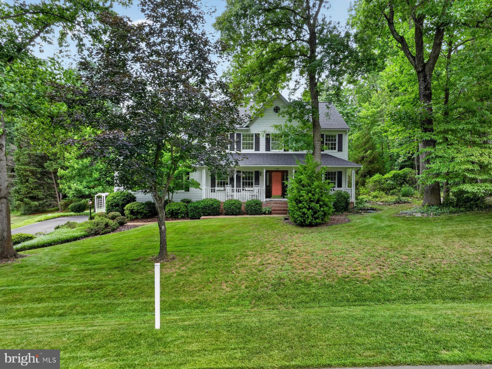 Set on a breathtaking .81-acre lot backing to peaceful woods, this quality-built Colonial offers exceptional space, privacy, and endless potential. Surrounded by mature landscaping in a picturesque community, the home features over 3,000 finished square feet above grade, plus an additional 1,909 square feet in the expansive unfinished lower level.
Designed with generous room sizes and a timeless floor plan, the main level is ideal for both everyday living and entertaining. The spacious kitchen, complete with a center island and dining area, opens to the dramatic family room featuring a vaulted ceiling, wood-burning fireplace, skylights, and a triple atrium door leading to the sizable deck overlooking the beautifully landscaped backyard. The formal living and dining rooms showcase hardwood flooring and elegant crown molding. A versatile main-level bedroom or office, also accented with hardwood floors and crown molding, adjoins a full bath that is conveniently accessible from both the room and the foyer.
Upstairs, three generously sized bedrooms provide comfortable accommodations. The primary suite features hardwood flooring, a walk-in closet, and a large private bath with a soaking tub, walk-in shower, dual vanities, and abundant room to create a luxurious retreat. A second full bath serves the additional bedrooms.
Recent updates include a new roof (2022), skylights (2016), and HVAC system (2018). The attached side-entry two-car garage offers valuable workshop space for hobbies, projects, or extra storage.
The unfinished lower level provides outstanding potential for future living space, whether envisioned as a recreation room, home gym, media center, guest suite, or all of the above. Outside, an irrigation system helps maintain the lush grounds, where mature trees, colorful plantings, and a serene wooded backdrop create a private oasis. The fantastic location enables residents to walk to the local AACPS school campus, ride bikes to Downs Park on the Chesapeake Bay and easily commute to Ft. Meade, Baltimore & Annapolis. Multiple marinas and favorite local restaurants are within just a couple of miles.  
While cosmetic updates will allow the next owner to add their own style and vision, the home's solid craftsmanship, desirable layout, and extraordinary setting provide an exceptional foundation for creating a truly remarkable residence. Schedule a tour today and experience everything peninsula life has to offer!