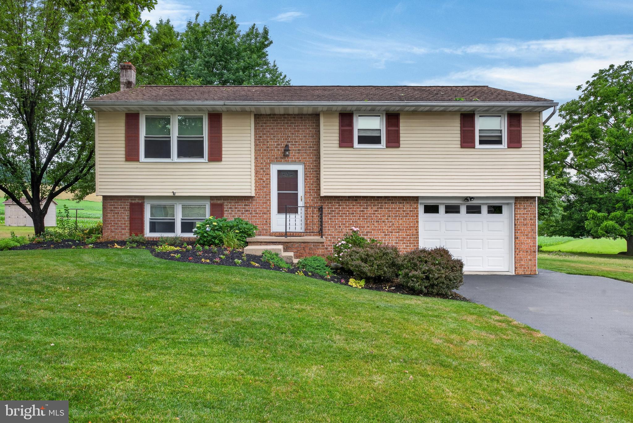 Open house today, Sunday, 3-4:30pm.
This well-maintained, one-owner home in Conestoga Valley SD is centrally located yet offers a gorgeous country view and complete privacy.  Pride of ownership shows in the many upgrades over the years: roof replacement, window replacements throughout, full bath renovation, new appliances, basement cabinetry and sink, deck replacement and more. Remote work and/or school is made easy with the basement built-in desks and filing drawers.  The laundry cabinetry provides convenient organization but also doubles as an ideal space for entertaining on the patio and serving food. Ductless mini-splits both heat and cool the main floor and the wood (or coal) stove creates a cozy warmth all winter. The oversized garage offers ample workshop space with the shed housing large lawn equipment. Just 10 minutes to the CV campus, downtown Ephrata or into Lancaster, you can't beat the location and the views.