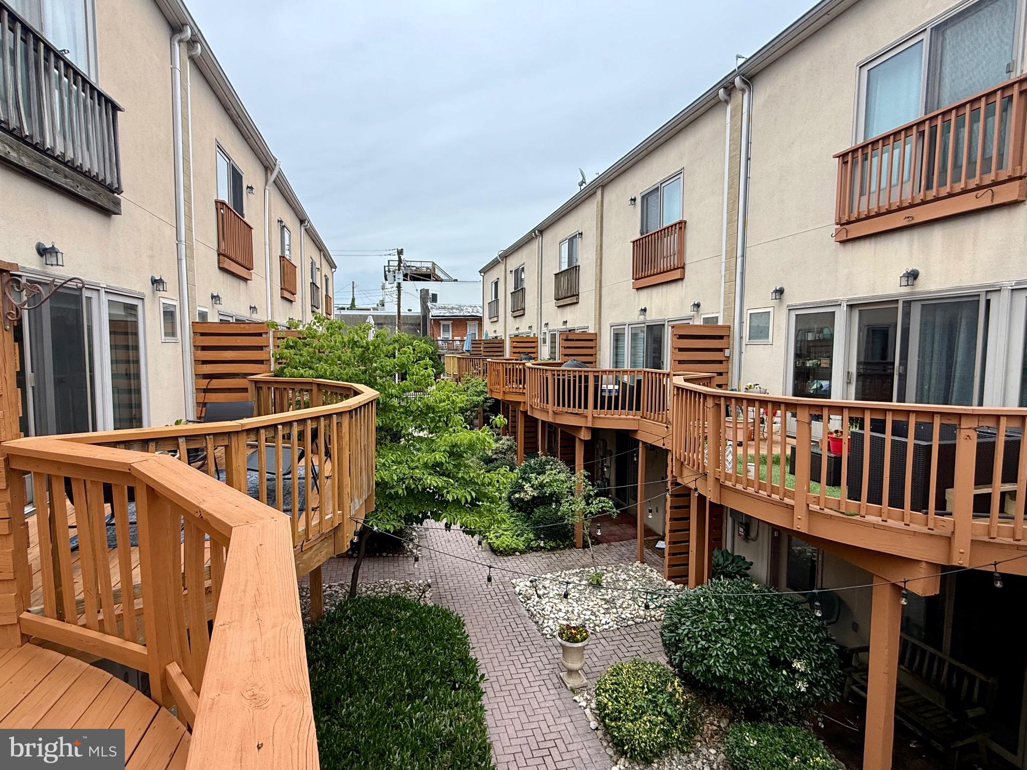 This price + this nice + this neighborhood = RARE find! Welcome to this spacious luxury end-unit townhome in the heart of highly sought-after Federal Hill, featuring an oversized one-car garage plus additional parking — a rare city find. Built in 2004, this newer construction home offers the perfect blend of modern convenience, generous living space, and unbeatable walkability. The main level features beautiful hardwood flooring, 9-foot ceilings, a gas fireplace, and an open, light-filled layout ideal for both everyday living and entertaining. The updated kitchen includes quartz countertops, glass tile backsplash, stainless Kenmore Elite appliances, and a breakfast bar that flows seamlessly into the dining area. Step outside to a private rear deck overlooking the courtyard, creating a peaceful retreat in the middle of the city. The spacious primary suite offers a marble bath with dual-sink vanity, while the lower-level bedroom and full bath provide excellent flexibility for guests, office space, or additional living needs. Located just blocks from Cross Street Market, Federal Hill Park, the Inner Harbor, M&T Bank Stadium, Camden Yards, restaurants, nightlife, and more, this home places you in the center of one of Baltimore’s most vibrant communities. Experience city living with space, style, parking, and location all in one.