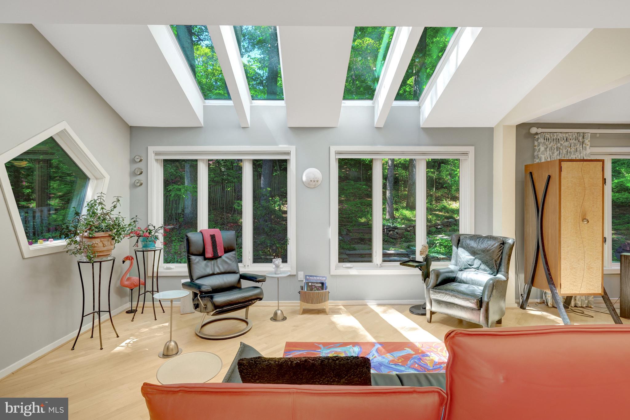 Stunning Contemporary Hardieplank home in the most incredible park-like setting including extensive hardscape and gardens! The owners have lovingly updated and cared for this home with so many beautiful upgrades, additions, custom windows & skylights, maple hardwood floors, and beautiful lighting. The hand-crafted cherry & padauk handrail on their staircase is truly a piece of art! As you enter the breath-taking custom Kolbe front door, you are greeted in the large foyer. The expansive main level offers a Living Room, Dining Room, Family Room with wood burning stove, Sun Room, Gourmet Kitchen, Laundry Room with custom pantry, and Powder Room. The showcase Kitchen has gorgeous Quartzite counters plus a live edge walnut breakfast bar, stainless Bosch oven & microwave-drawer, Sub-zero Refrigerator, Miele 3-tiered dishwasher, and Plato cabinets! The upper level includes the Primary Bedroom with balcony, Primary Sitting Room, custom designed Primary Bathroom with walk-in shower, 2 additional generous size Bedrooms, Study, & updated second Bathroom. All bedrooms have lots of closets including an easy-access door to a floored storage space. The lower level is quite spacious with 3 large Recreation Rooms, a gas fireplace, spa-like Bathroom, and a well-designed utility room including a workshop, handy utility sink & cabinet, and a tankless water heater. The yard is so inviting with gorgeous curved stone walls, stone walkways, year-round low-maintenance perennial gardens, patios, decks, porch & balcony, AND a private grassy oasis in the backyard for running around or sitting by a firepit! The schools are top notch with Waples Mill ES, Franklin MS, and Oakton HS! And a membership to the Oakton Swim & Racquet Club can be purchased directly from the owners as a separate bill of sale. This home truly brings the outside, in! You Will Fall in Love!!