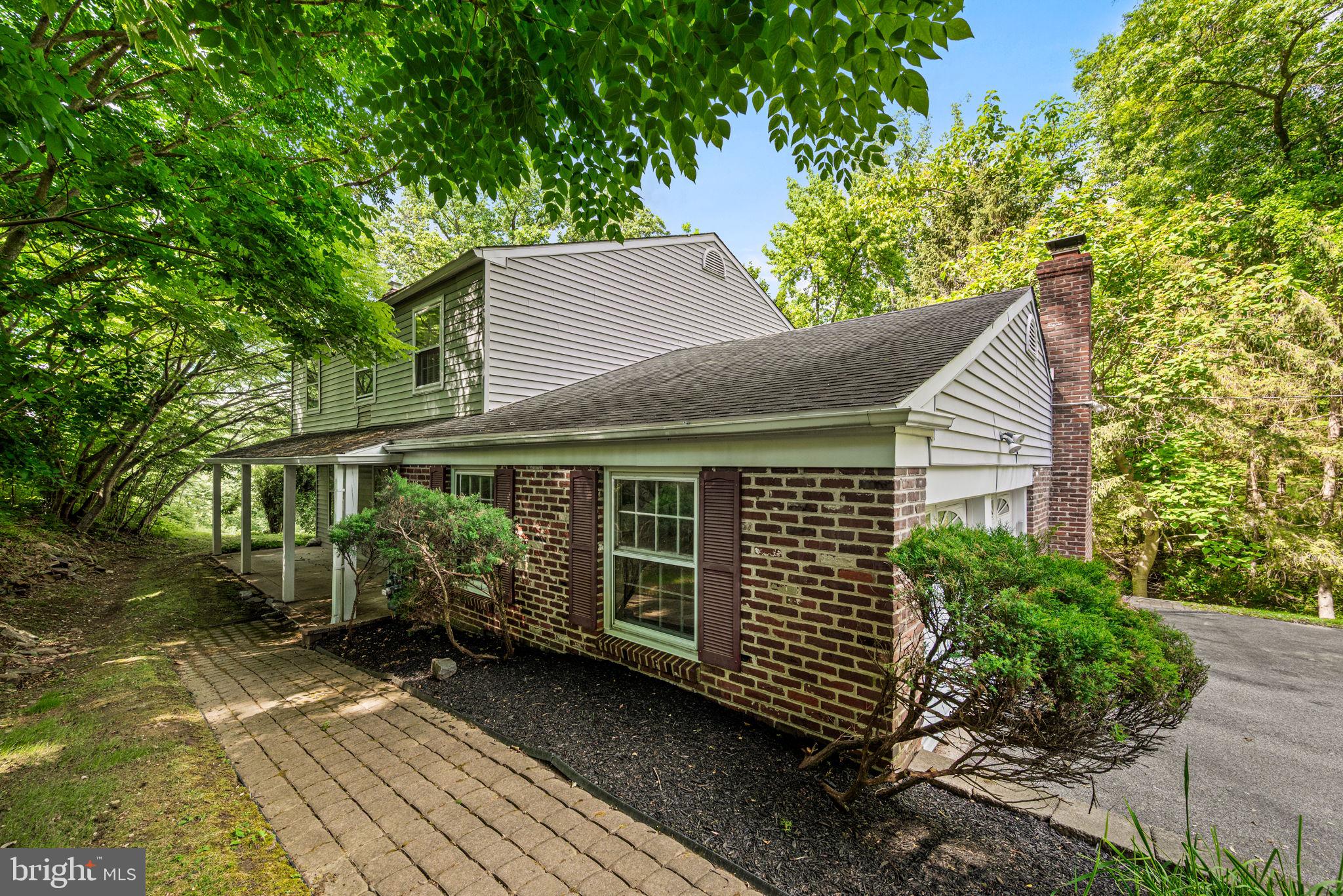 Nestled on a picturesque 1.92-acre lot in Whitemarsh Township surrounded by mature trees and serene natural views, this stunning colonial offers the perfect blend of elegance and modern comfort. From the moment you enter, you’ll be captivated by the dramatic curved staircase and inviting layout designed for both everyday living and entertaining. Located at the front of the home, the living room features a wood-burning fireplace for warm and comfortable gatherings. The heart of the home is the updated kitchen featuring granite countertops, abundant cabinetry, and controlled heated floors that make every season comfortable. The sunroom extends off the kitchen and serves as a retreat with breathtaking views of the peaceful backyard, which opens directly to the spacious deck, providing the perfect setting for outdoor dining or simply enjoying the surrounding scenery. The family room, complete with a cozy wood-burning fireplace, creates a warm gathering space. Next to the kitchen is the expansive dining room, ideal for hosting holidays and special occasions. Upstairs, the second floor has been reconfigured to create an impressive main suite with an oversized walk-in closet and luxurious en-suite bath with a double vanity, jacuzzi tub, separate shower, and comforting heated tile flooring. The lower level adds exceptional living and storage space, featuring ground-level walk-out access, laundry, two cedar closets - one of which could be converted to a half bath. Additional highlights include two-zoned heating, a pull-down attic above the garage, a fenced-in yard, and a new roof. This wonderful property offers peaceful yet convenient living just moments from beautiful Wissahickon Creek, where biking and hiking trails, golf, and nature are right outside your door, all within the sought-after Whitemarsh Elementary School area.  A rare opportunity to enjoy space, privacy, and a coveted location all in one home.