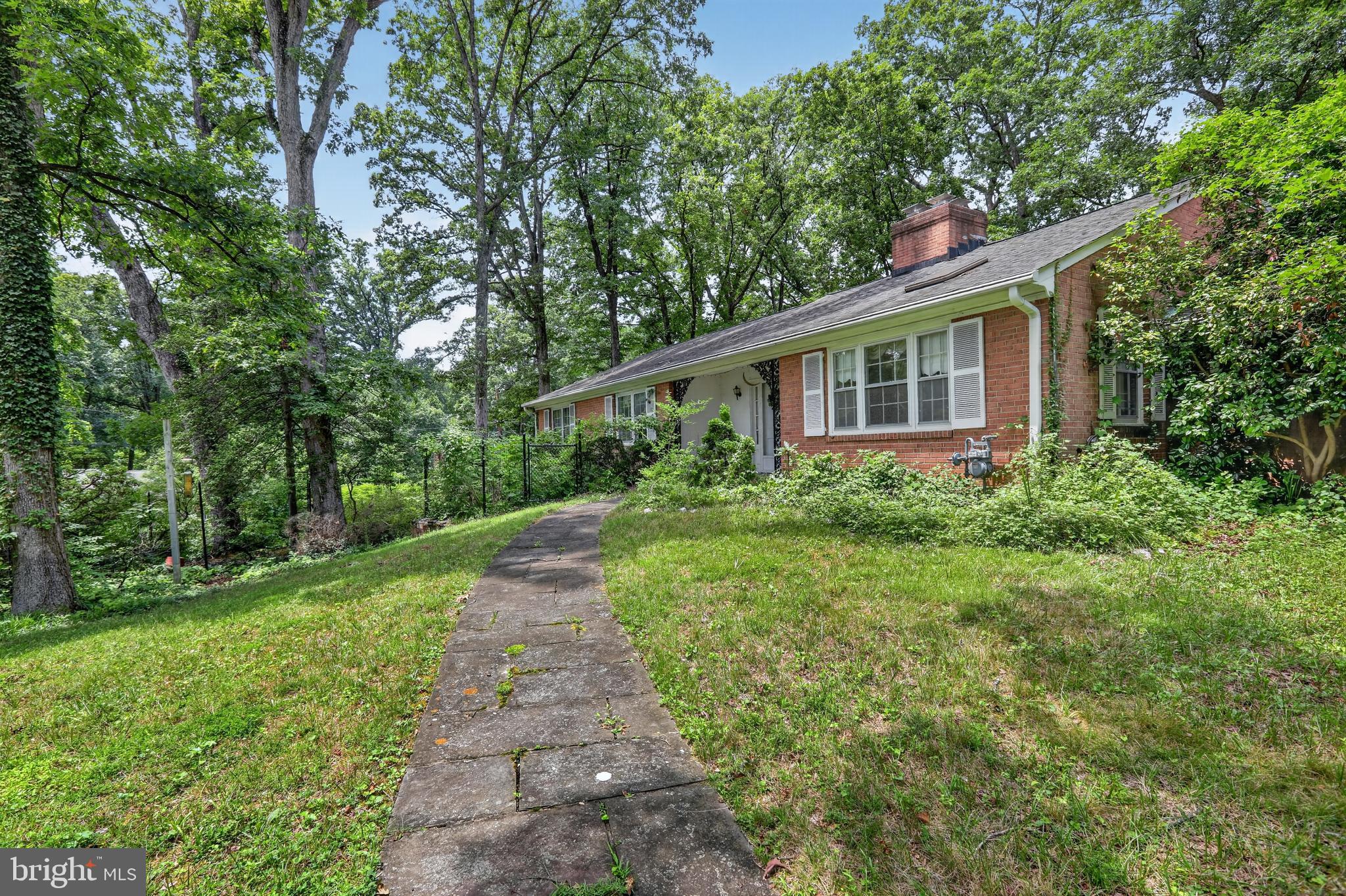 Set on a private, wooded lot of nearly an acre, this 4-bedroom, 3-bath home offers a rare opportunity to create your dream home in a peaceful, tucked-away setting. With spacious interiors and expansive outdoor space, this property is full of potential and ready for your vision.

Inside, the home features a generous layout with multiple living areas, including a living room with a fireplace that anchors the main space. The flexible floor plan provides room to reimagine and customize, with plenty of square footage to design a layout that fits your needs. The finished walkout basement adds even more versatility, offering space for a recreation area, additional living space, or future enhancements.

The kitchen and main living areas connect easily, while the bedrooms are generously sized, providing a strong foundation for updates and personalization. This property is being sold as-is, presenting an excellent opportunity for buyers looking to renovate, invest, or build equity over time.

A 2-car garage and extended driveway provide ample parking and convenience. Outdoors, the nearly one-acre lot is surrounded by mature trees, creating a private, natural setting with endless possibilities for outdoor living, expansion, or landscaping enhancements.

Ideally located just off New Hampshire Avenue near Powder Mill Road, the home offers easy access to the University of Maryland, the FDA campus, and major commuter routes including I-495 and I-95. Shopping, dining, and everyday conveniences are nearby, along with parks and green space.

A unique combination of location, land, and opportunity—bring your ideas and make this property your own.

Some images may reflect virtual staging or digital editing, including removal of personal property, to help showcase the home.