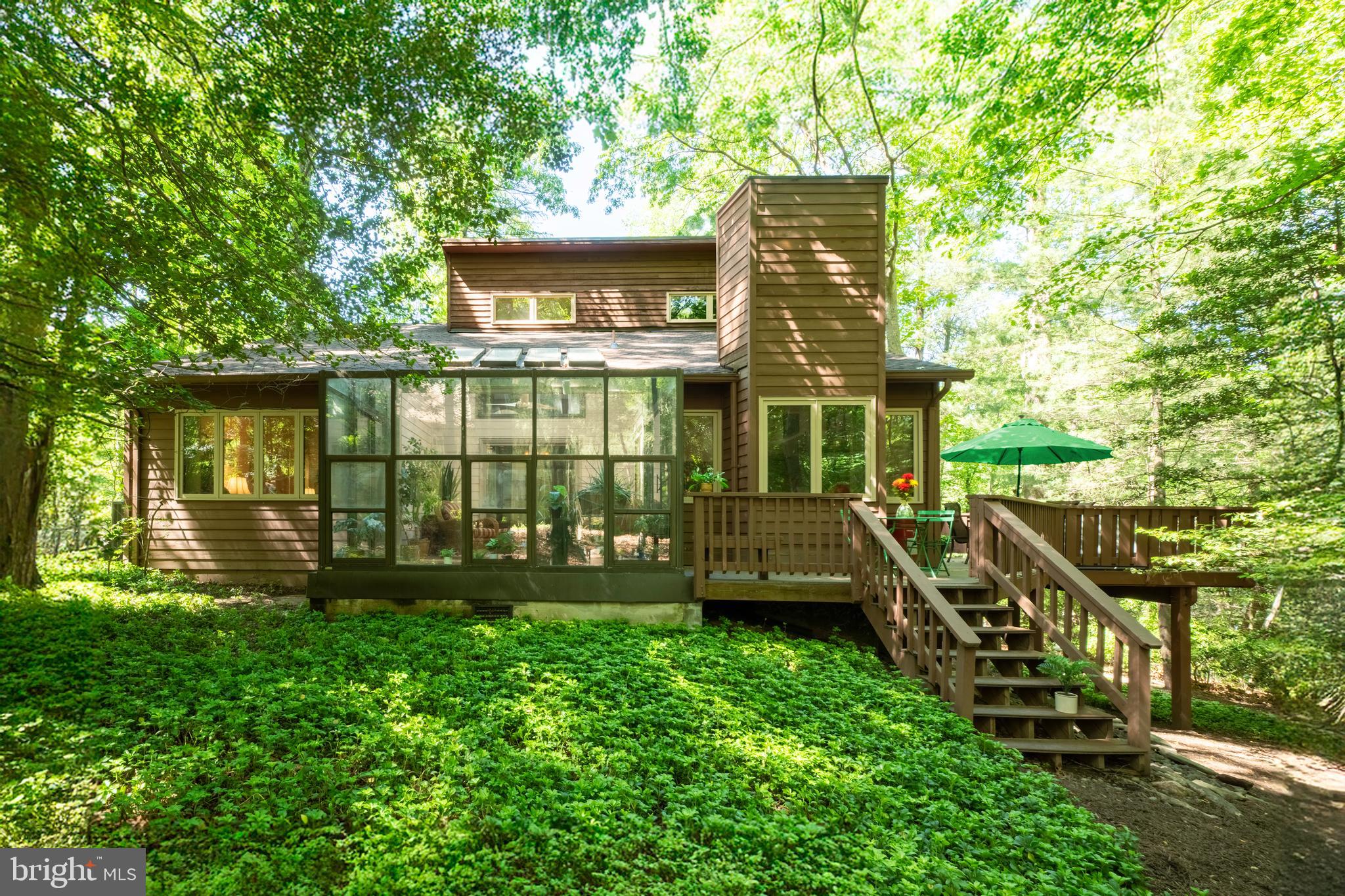 Lake Audubon Access – Embrace Nature and Contemporary Living. Experience the perfect blend of tranquility and modern design in this carefully maintained home offering over 2,880 square feet of light-filled living space. With a new roof and skylights installed in Spring 2025, this 4-bedroom, 3-bath residence is well maintained and move-in ready. The main level features a spacious open floor plan with vaulted ceilings, skylights, and hardwood floors that seamlessly connect the kitchen, dining, family, sun, and living rooms—ideal for both entertaining and everyday living. A flexible room adjacent to a full bath with a tub/shower can serve as a bedroom or a private home office. Step outside through sliding glass doors onto the wraparound deck, nestled among mature trees and nature - a bird watcher’s paradise (see the video). Unwind year-round in the sunroom with a 5-person hot tub, perfect for relaxing after a long day. A generous laundry/mudroom off the kitchen leads to the attached garage. Upstairs, the primary suite features soaring ceilings. High windows with remote-controlled electric blinds offer darkness or peaceful ambiance under the stars. Two additional bedrooms and a full hall bath complete the upper level. The walk-out lower-level recreation room offers versatile space, is kept cozy with baseboard heat, and features a wet bar with cabinets and counter space. The large unfinished utility/storage area includes high-quality rolling metal shelving that conveys with the home. Located just a 3-minute walk to your private community dock on Lake Audubon and within walking distance to the nearby swimming pool, tennis courts, Nature Center, plus the middle and high schools, this property offers a unique opportunity to enjoy peaceful, nature-filled surroundings with full access to Reston's premier amenities. Bring your kayaks, paddleboards, and sports gear—nature and adventure await just steps from your new home.