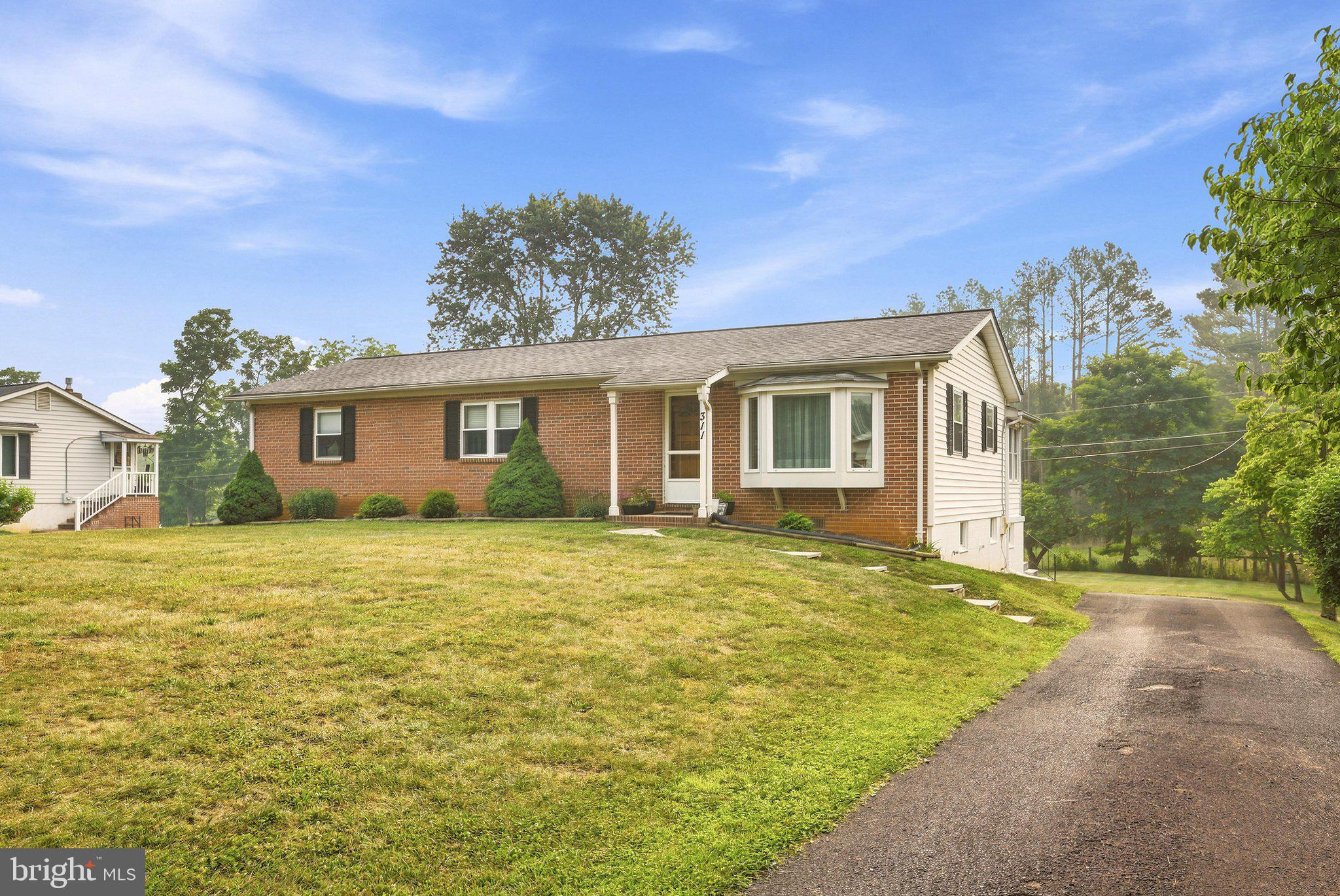 This well-maintained ranch-style home reflects true pride of ownership and is located in Clarke County—a rare opportunity! Enjoy convenient access to Route 7, Winchester, and Northern Virginia while savoring the peace and privacy of country living.
The spacious primary suite features a private en-suite bath, while the generously sized secondary bedrooms provide plenty of additional space. The updated kitchen offers a breakfast bar and newer stainless steel appliances, making it both functional and inviting.
An enormous sunroom provides year-round living space and is perfect for relaxing, entertaining. The remodeled bathrooms add modern style and comfort throughout the home.
The partially finished basement offers exceptional flexibility, featuring a family room, great room, hobby room, game room, workshop with endless possibilities for customization.
Outside, you'll find a paved driveway, a large one-acre lot backing to farmland and mature trees for added privacy, and a spacious outbuilding ideal for storage, hobbies, or equipment. This property combines comfort, convenience, and versatility in a beautiful country setting.