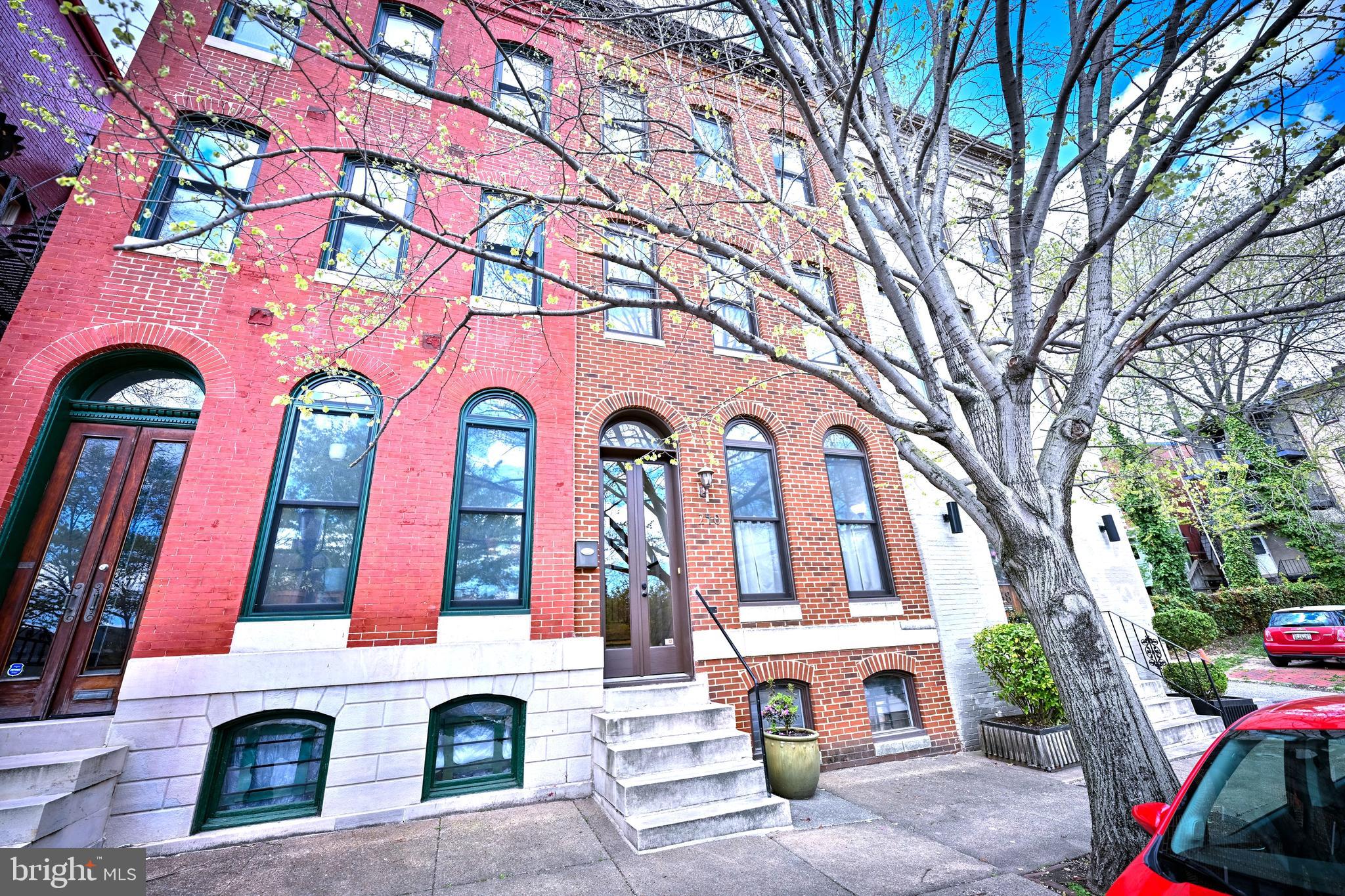 Welcome to 240 Wilson Street in historic Bolton Hill—a simply stunning home that blends classic charm with modern style.

This beautifully renovated home has 4 bedrooms and 3.5 bathrooms spread across four finished levels, giving you plenty of space to live, work, and relax. Sunlight fills every room through large windows and multiple skylights, highlighting the gorgeous hardwood floors and high ceilings throughout the home.

As you enter the home from the large glass front double doors, you are welcomed main foyer that leads to a spacious living room with alcove. Seamlessly flowing into the dining area, this level has 2 decorative fireplaces (gas lines disconnected).

The gourmet kitchen is a true standout, featuring granite countertops, a decorative tile backsplash, stainless steel appliances, a commercial-grade range, and custom cabinets—perfect for cooking and entertaining. Off the kitchen, you’ll find a fenced rear brick patio, ideal for relaxing or hosting guests.  

On the second level of the home you will find 3 ample sized bedrooms and two full bathrooms, including one of two primary suites in the home. Each bathroom has been tastefully updated with stylish finishes. 
One of the dual zone units is located on this level as well.

The top floor of the home comprises the private primary suite retreat. It includes a spacious bedroom, a luxury bathroom with glass tile, and your own private balcony—perfect for enjoying your morning coffee or unwinding at the end of the day.

The lower level offers a bright and flexible space that can be used as a rec room, home office, or both. Moreover, the unfinished portion can be used for a workroom or is perfect for additional storage. The second zone heating and cooling system, water heater and laundry are located here.  NOTE: The AC portions of the dual zone systems were replaced in both units in 2019.

This home truly has it all—space, style, and a prime location in one of Baltimore’s historic neighborhoods (on both local and national historic registries).  And as such, homeowners are bound by rules to preserve the neighborhood’s historic character. Any exterior changes to homes in Bolton Hill must be in keeping with historic preservation standards, as approved by Baltimore City’s CHAP division.

Bolton Hill is also part of the Part of the Mid-Town Benefits District, a neighborhood advocacy and improvement group , which provides cleaning, greening, and safety services as well as community advocacy and activities. These extra services are paid via an additional fee by all residents within these Districts.