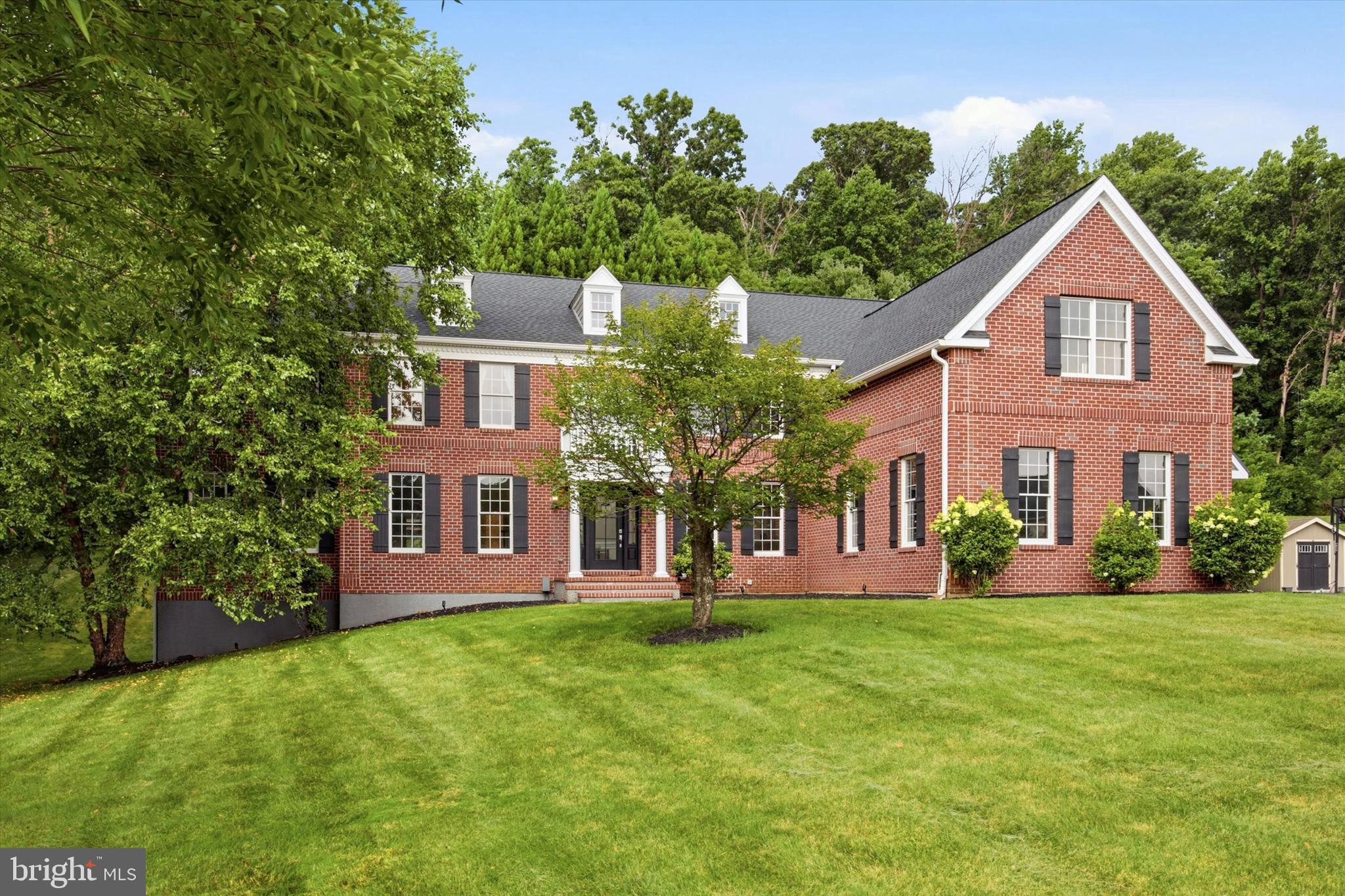 Welcome to 1659 Linda Drive, an exceptional luxury residence in the prestigious Estates of Tattersall, where timeless elegance meets sophisticated modern living. Offering 7,117 square feet of beautifully designed living space, this extensively renovated home showcases exceptional craftsmanship and meticulous attention to detail throughout—including peace of mind provided by a brand-new roof backed by a 25-year transferable warranty. Perfectly positioned on a premium lot surrounded by mature landscaping and tranquil wooded views, the property offers the rare combination of privacy, natural beauty, and a warm, welcoming neighborhood atmosphere.

A dramatic two-story foyer with a sweeping curved staircase sets the tone, introducing rich architectural millwork, updated designer lighting, a whole-home surround sound system, and brand-new 5-inch solid hardwood flooring. The floor plan offers an effortless balance of elegance and functionality, featuring formal living and dining rooms, a spectacular conservatory, a private executive office, and an impressive two-story family room. Flooded with natural light from a breathtaking wall of arched windows, the family room is anchored by a new floor-to-ceiling custom fireplace with a new propane gas insert.

At the heart of the home, the reimagined gourmet kitchen features newly refinished cabinetry, new quartz countertops and a dramatic waterfall island with custom storage, a new cooktop, and a walk-in pantry. The open-concept layout flows seamlessly into the breakfast room, where ideal orientation allows sunlight to pour in throughout the day, framing ever-changing seasonal views.

Upstairs, the second level hosts five generously sized bedrooms. The primary suite offers a private sitting area, dual walk-in closets, and a renovated spa-inspired bath with a custom oversized walk-in shower, new dual vanities, and a soaking tub. Two secondary bedrooms feature private en-suite baths, while two additional bedrooms share a Jack-and-Jill bath, complete with exceptional closet storage.

The professionally finished 1,550 sq. ft. walk-out lower level rivals the finest custom homes. Designed as an entertainer's dream, it features a custom wet bar with a waterfall quartz island and wine fridge, a recreation area with a sleek fireplace, a full bath with a walk-in shower, a flexible room with a walk-in closet, and space for a home gym, media room, or office. Complementing this fantastic lower level is a well and thoughtfully planned layout that also leaves more than 1,000 square feet unfinished, providing plenty of room for convenient storage.

Completing the home’s interior amenities, the oversized three-car garage is accompanied by a spacious driveway in front of the garages, which allows for max 8-car parking, making driving in and out easier. The garage itself features epoxy-coated flooring and a Tesla EV charging station.

Outdoor living is equally impressive with expansive paver patios, professional hardscaping, and peaceful wooded views within a scenic golf community. A truly move-in ready luxury offering in one of Chester County's most sought-after locations!