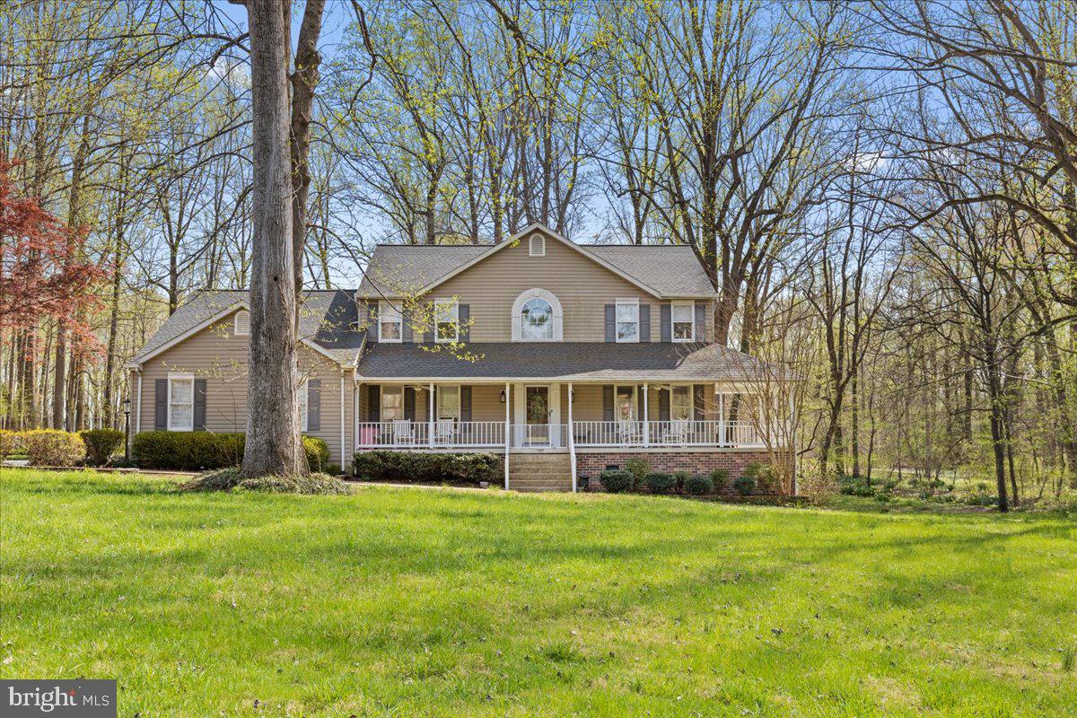 Are you tired of seeing the same floor plan over and over again? Prepare to be impressed by the custom features this exceptional home has to offer. Ideally located just 30 minutes from Washington, DC, approximately 40 minutes to Annapolis and Alexandria, and about 20 minutes to Joint Base Andrews, this property offers both convenience and privacy in a peaceful setting.

The kitchen showcases beautiful cabinetry with glass-front doors, interior lighting, stainless steel appliances, granite countertops, and a charming breakfast area complete with skylight and window seating. Adjacent is an expansive gathering space with fireplace seating that easily accommodates large gatherings.

The true centerpiece of the home is the stunning 22' x 22' conservatory-style family room, surrounded by walls of windows that fill the space with natural light and create an inviting atmosphere year-round. Just outside, a spacious deck provides the perfect setting for outdoor entertaining.

The main level also features a private office or optional bedroom, formal living room, and entertainment room—all accented by hardwood flooring. Upstairs, hardwood floors continue throughout. The primary suite offers a walk-in closet and beautifully remodeled bath with double sinks and a spacious walk-in shower. All secondary bedrooms are generously sized, with one currently serving as an oversized custom closet.

The lower level includes a bright recreation room with abundant windows and walk-out access to the backyard, a full bath, separate den or study area, and a wet bar—ideal for entertaining guests.

This one-of-a-kind home is a rare opportunity in a desirable Northern Calvert location. Assumable FHA loan with lender approval  approximately $610,000 at 3.25%