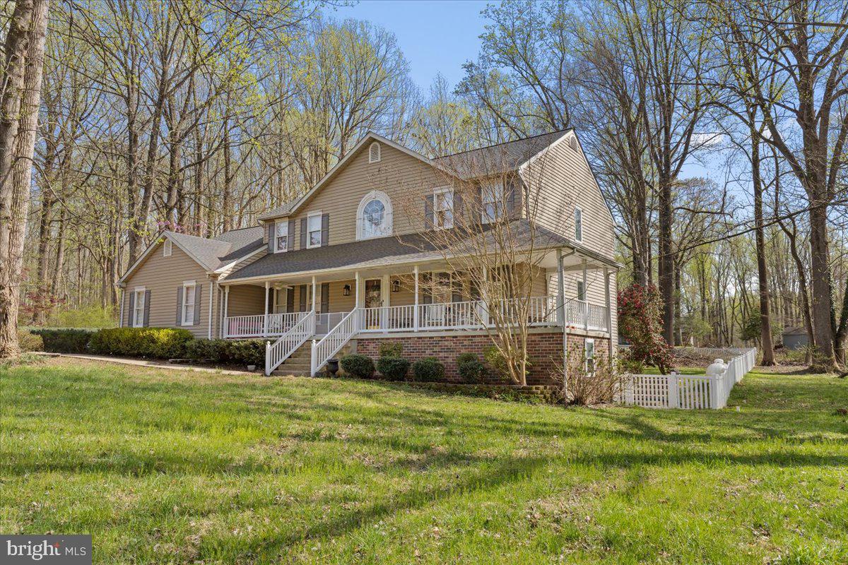 Do you enjoy entertaining? This is the perfect home for you! Beautiful  spaces are scattered throughout the first floor. Massive dining room with fireplace, family room surrounded by windows which leads out the back yard deck and fenced yard.  Prepare to be impressed by the custom features this exceptional home has to offer. Ideally located just 35 minutes from Washington, DC, approximately 40 minutes to Annapolis and Alexandria, and about 20 minutes to Joint Base Andrews, this property offers both convenience and privacy in a peaceful setting.

The kitchen showcases beautiful cabinetry with glass-front doors, interior lighting, stainless steel appliances, granite countertops, and a charming breakfast area complete with skylight and window seating. Adjacent is an expansive gathering space with fireplace seating that easily accommodates large gatherings.

The true centerpiece of the home is the stunning 22' x 22' conservatory-style family room, surrounded by walls of windows that fill the space with natural light and create an inviting atmosphere year-round. Just outside, a spacious deck provides the perfect setting for outdoor entertaining.

The main level also features a private office or optional bedroom, formal living room, and entertainment room—all accented by hardwood flooring. Upstairs, hardwood floors continue throughout. The primary suite offers a walk-in closet and beautifully remodeled bath with double sinks and a spacious walk-in shower. All secondary bedrooms are generously sized, with one currently serving as an oversized custom closet.

The lower level includes a bright recreation room with abundant windows and walk-out access to the backyard, a full bath, separate den or study area, and a wet bar—ideal for entertaining guests.

This one-of-a-kind home is a rare opportunity in a desirable Northern Calvert location. Assumable FHA loan with lender approval  approximately $610,000 at 3.25%