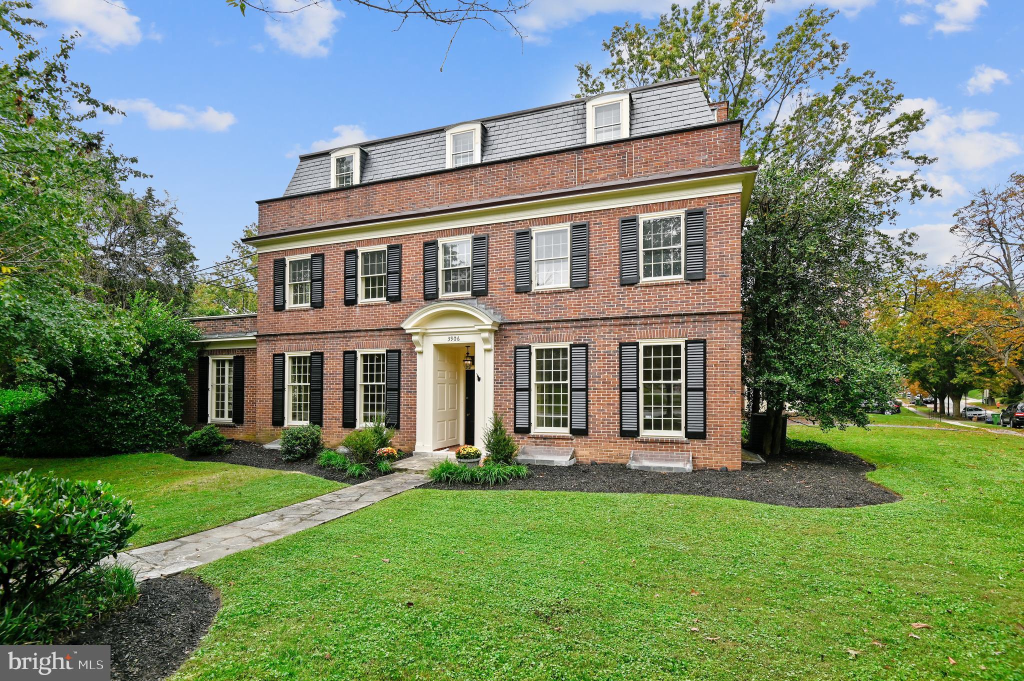 Gracious Guilford Georgian on landscaped corner lot. This 7 bedroom, 3 full bath/2 half bath home offers plenty of space for family and entertaining. Enter through the front portico to a spacious foyer with an elegant library/office with built-ins to your right and a formal living room with wood burning fireplace to your left. Beyond the living room is a cozy den/sun room which leads you into the large eat-in kitchen with coffered ceilings. A butlers pantry, large dining room with plantation shutters, and a half bath complete the main level. Second level houses the primary bedroom suite with a roof top terrace attached, large walk-in closet, and 2 bedrooms with a jack & jill bath. Top level provides 4 more bedrooms and a hall bath. Finished lower level has a large rec room with new flooring, laundry room, half bath, and plenty of storage. Just waterproofed with a 5 year warranty. Recent renovations also include all new custom shutters, new water main, refinished hardwood floors, and freshly painted throughout. Spacious yard with stone patio. 2 car garage & 2 zoned A/C.