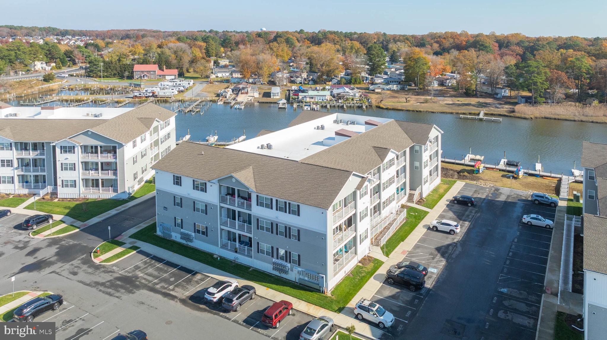 PRICED TO SELL WITH WATER VIEWS!!!  Enjoy water views of Love Creek from all rooms of this beautiful top floor end unit!  No need to hear the footsteps of someone above you!  Located in a gated community approx. 7 miles from both Rehoboth Beach and Lewes, this 6-year young condo features split bedrooms, LVP flooring throughout, granite countertops throughout and stainless-steel appliances, a massive primary BR, and access to the large balcony from all rooms.   Primary bath features double vanity, large tile shower with frameless glass enclosure. The community features gated entrance, secure building access, elevators, outdoor pool, kayak storage and launch.  The community offers 58 boat slips that can accommodate up to a 35' boat (available on a first-come basis, annual lease of approx. $3K/yr) Also located next to the Freedom Boat Club where members can enjoy use of the boats without the expenses of caring for one!  Bus stop located at entrance to the community, so you don't have to drive to the beaches!  Low condo fees and low taxes as well. Perfect as a primary residence, vacation home or rental investment (7-day min.)!! Check it out ASAP!