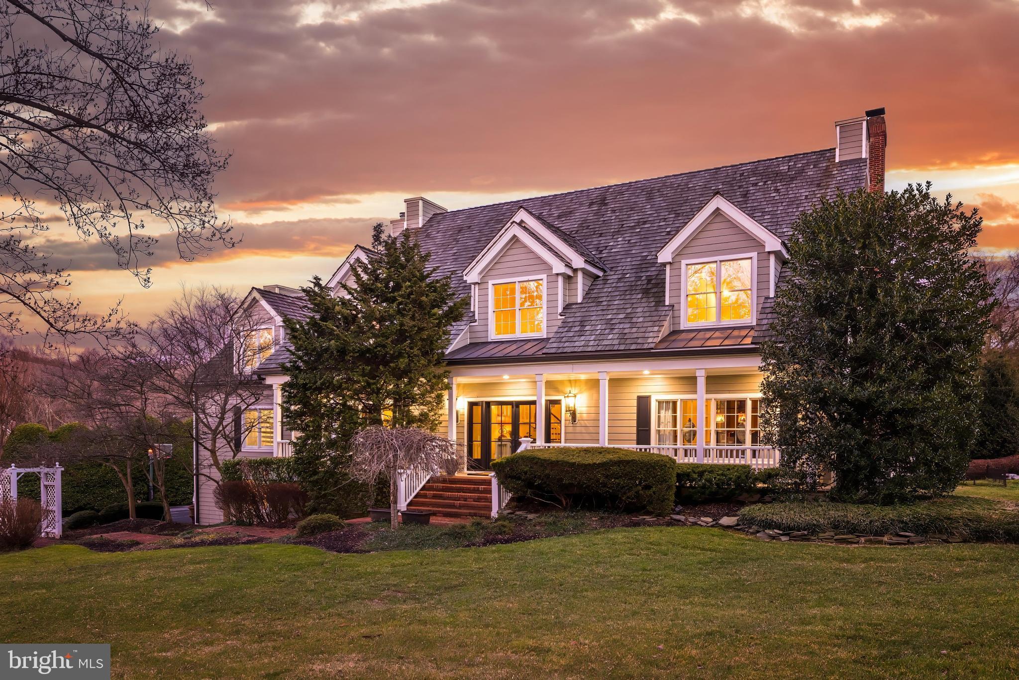 Introducing 539 Springvale Road in the heart of Great Falls. This picturesque cape cod is situated on 2.36 beautifully landscaped acres with a dream backyard pool, extensive hardscaping and custom interior details. Nestled against a delightful pond, each room in the back of the house enjoys serene views of its natural backdrop. Vacation at home with a stunning heated swimming pool, hot-tub, built-in BBQ grill and fire pit area. Meticulously maintained with new HardiePlank siding, cedar shake roof, and a renovated kitchen, primary bathroom, and lower level. 

Inside you are greeted by classic charm with gleaming hardwood floors, molding and trim, built-ins and 9'+ ceilings. The main level includes a formal dining room, sitting room, and a grand 2-story family room with ample sunlight, a beamed ceiling, and cozy brick mantel fireplace. The eat-in chef's kitchen features a center island, perfect for gatherings, and top of the line appliances. Double access from the kitchen to the covered decks with ceiling fans and views of the backyard oasis. The main level also offers a private primary bedroom and its spa-like en-suite bath. Delight in the sunlit 2-story bath with a vaulted ceiling, a double sided gas fireplace and centerpiece soaking tub. His-and-hers walk-in closets are custom built with shelving and drawers. Charming spiral stairs take you up to a loft area with a cedar closet and additional storage space. Plenty of room to customize this space to fit your needs - make this your home office, a yoga room, or a private space for respite. Three generous bedrooms upstairs all include en-suite baths and inviting dormer windows. The upper level landing has gorgeous built-ins and offers optional space for a home office or library. Tailor the second loft area as a 6th bedroom or a bonus playroom! The walk-out lower level is completed with a wet-bar which houses a wine fridge, and is perfect for family movie or game nights. A full bedroom and bath are perfect to use as an in-law suite or for overnight guests. 

Enjoy a spacious three-car garage and plenty of available parking in the driveway which is accessible by Down Patrick Lane. Located in the desirable Langley High School pyramid and minutes to Tysons Corner, I-495 and the GW Parkway, this is true lifestyle property in the heart of Great Falls. Welcome home!