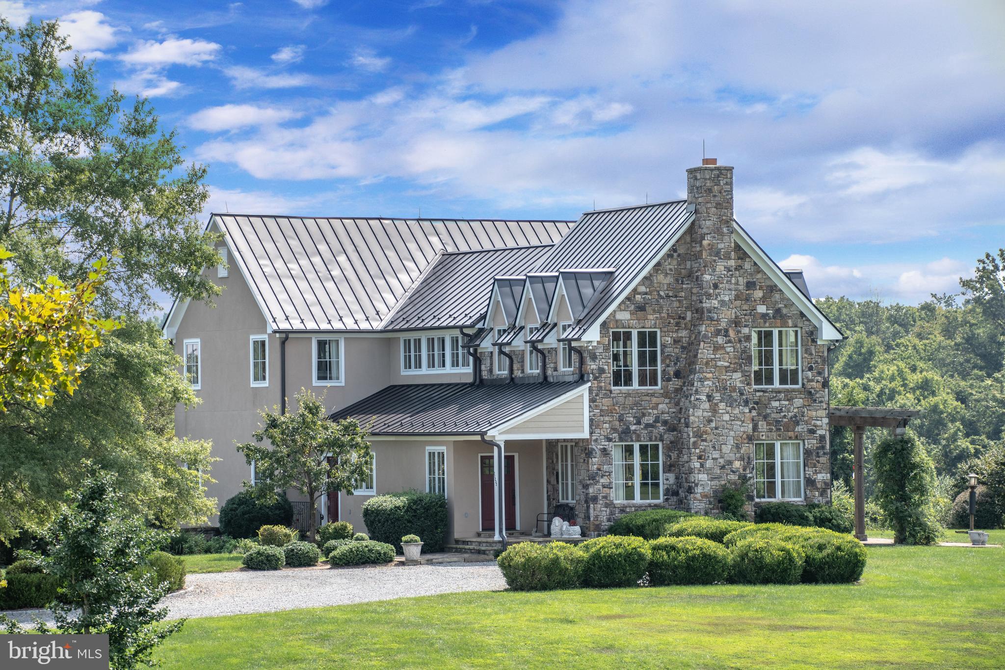 Good Home Farm, known for its name, sits in a storybook setting surrounded by large estate farms in the heart of horse country.  Located in the quaint village of Unison, this property is in the center of the Piedmont Hunt territory.  Having had only one owner in nearly 20 years, it's a rare opportunity to own this turnkey, private, premier equestrian estate.  Nestled to the back of 50+ acres sits a custom-built 3-bedroom, 4-bathroom stucco & stone home, constructed with extraordinary detail, quality, and charm.  The main level showcases a great room with wooden beams, Pella windows on three sides, and features a floor-to-ceiling stone wood-burning fireplace.  Gorgeous hardwood floors flow through the open kitchen, living, and dining area and throughout the main level.  Three sets of french doors open from the family room to an outside stone terrace off the back of the home where you will enjoy an abundance of wildlife.  You will see birds, butterflies, fox, deer, and wild turkey wander the trails in the woods down to the creek.  Just inside the french doors, is a gourmet kitchen with tons of cabinet space, top-of-the-line stainless steel appliances, and beams of natural light.  A large mudroom was perfectly placed with a sink and laundry, and a closet on each level was thoughtfully designated for space for an elevator, if needed.  On the main level is a grand primary suite, with a luxurious bath and walk-in closet.  Additionally, the primary suite has its own private room with a vaulted ceiling, great for an office, or tv room, with three walls of Pella windows and doors that lead out to a private side porch.  A common area sits at the top of the stairs on the upper level with built-in bookshelves, tons of light, french doors off the back, and stunning views in every direction!  Two very generous size bedrooms with high ceilings are on the upper level, each with their own full bath.  On the lower level you will find a storage area, a 2-car garage, and an additional room great for a gym or any hobby.  Down the tree lined driveway, sits an exquisite 4-stall elite equestrian facility. The stable features a wash-stall with heat lamps, grooming stall, feed room, utility room, and a tack room with a washer, mini-refrigerator, and a bathroom of its own.  Out the back of the stalls is a lean-to run-in shed, and paddock which can serve as a dry lot too.  Rubber tile pavers line the center aisle down to a 70x170 indoor riding arena with a manufactured bluestone base, and dust-free rubber tire footing with mirrors on each end.   One side of the indoor is open at the top for the perfect light and amount of air flow for the horse and rider.  Opposite the barn, on the right wing of the indoor is a farm workshop that was designed to easily be converted to additional stalls.  On the backside of the workshop is covered space ideal for housing farm equipment.  4-large paddocks surround the facility, each with 3-board fencing, run-in sheds, and auto waterers.  Fenced garden beds are just beyond the barn too.  The house and barn roofs were all replaced in 2016, the main home furnace was replaced in 2019, in addition to the heat pump and furnace on the upper level.  Good Home farm has lots of loving animals so all showings must be scheduled in advance with the listing agent.  This perfect all-weather indoor riding along with endless ride-out awaits you!  Make an appointment today, you won't be disappointed!