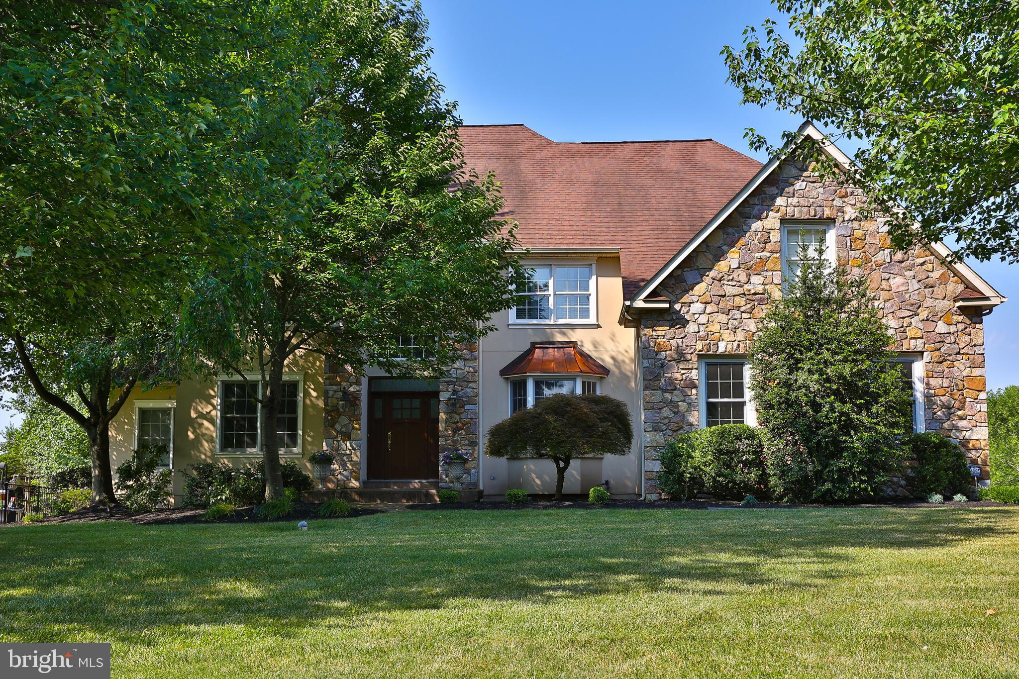Welcome to this outstanding and incredibly spacious 5 Bedroom, 5 FULL and 1 Half Bath, 3-Story Colonial with a 3-car garage in the highly coveted Normandy at Blue Bell neighborhood with 6800 SF of living space. This home is ideally positioned within the community, backing up to over 12 acres of preserved open space offering a private setting and enough room to test your golf game too. Natural light greets you as you enter the home’s 2-Story Foyer with both formal Living and Dining Rooms flanked on either side featuring 9' ceilings, hardwood floors, and custom millwork, adding to the home's charm. The stunning 2-story Family Room is a showstopper, topped with an incredible Restoration Hardware chandelier and also features one of two gas fireplaces, and connecting to two separate Butler's Pantries, including one with a wet bar. The heart of the home is the spacious Kitchen, complete with a center island, Corian countertops and ceramic tile backsplash. This space opens to a fabulous Sunroom with walls of windows, offering breathtaking views of the deep, beautifully landscaped rear yard. A first-floor office is one of several options for those working from home.  The powder room and laundry complete this floor. Two sets of stairs provide easy access to the 2nd Floor, where the luxurious Owner's Suite awaits. This suite features a bedroom with a tray ceiling, and the Sitting Room has been transformed into an amazing walk-in, professionally organized closet with a granite island.  Light-filled bathroom includes a tiled shower with a frameless glass door, a whirlpool tub, and a vaulted ceiling. An ensuite bedroom and two additional bedrooms sharing the hall bath with tub-shower complete the second level. The 3rd finished third floor is versatile, serving as a 5th Bedroom, In-Law Suite, or Home Office, with three built-in workstations, a Full Bath, and a separate HVAC zone. One of the major highlights of this home is the recently updated and refreshed finished basement. This exceptional space includes a Recreation Room with gas fireplace, a renovated full bath, an industrial-style Workout Room perfect for fitness enthusiasts, and an additional home office providing the ultimate in convenience and functionality. Additional features include ceiling fans, central vacuum, recessed lighting, and hard-wired speakers in most rooms. A sliding French door from the Sunroom opens to a spacious Trex deck, perfect for outdoor gatherings, overlooking the gorgeous grounds with an in-ground sprinkler system. Located in the top-rated Wissahickon School District,  this neighborhood is just minutes from excellent shopping, restaurants, and multiple train stations.
This is truly a one-of-a-kind property offering an unbeatable combination of amenities, functionality, and location. Don't miss your chance to make this stunning home yours!