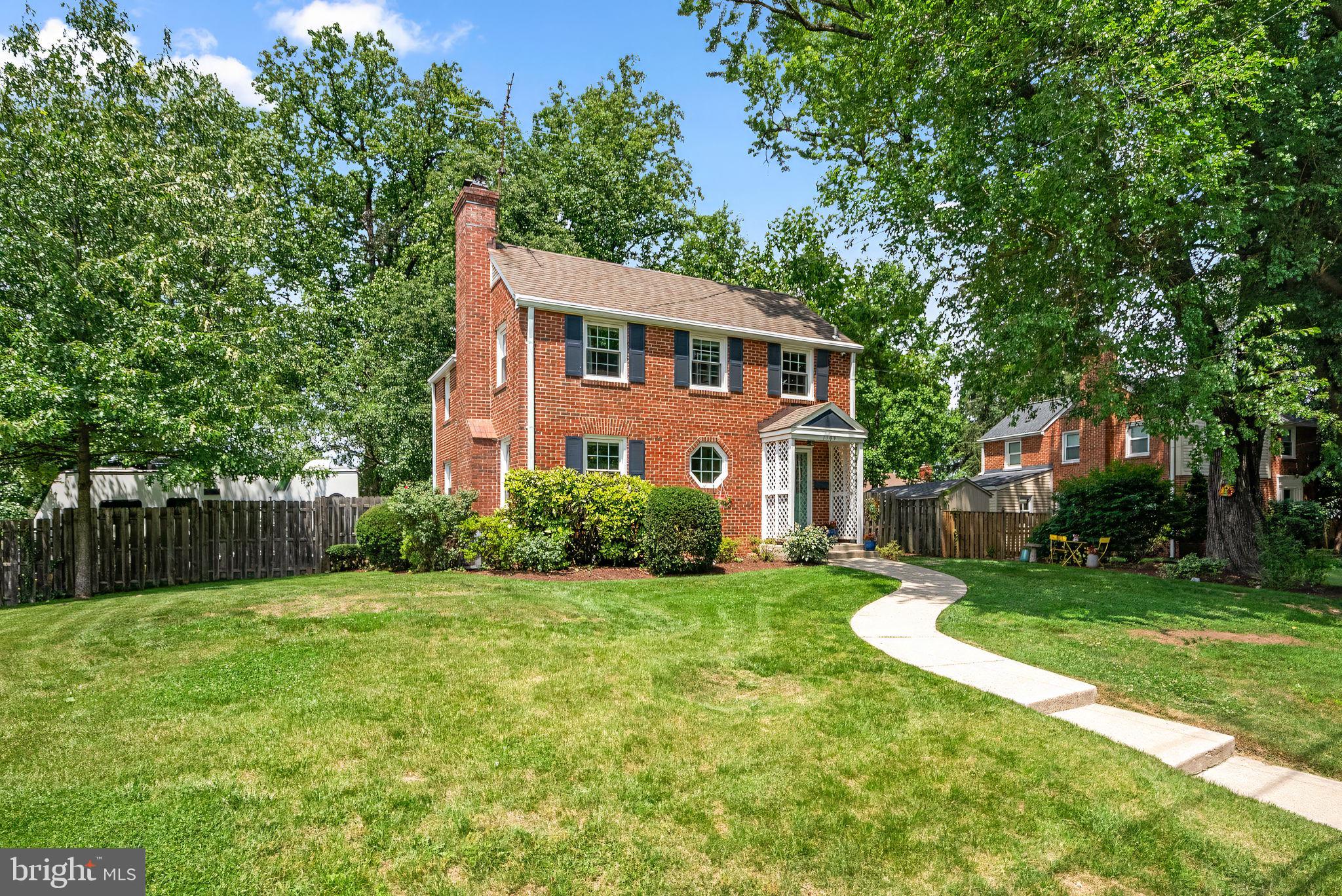 Welcome home to 1709 White Oak Dr, where classic 1940s charm meets modern comfort in the heart of Woodside Forest. Set on a generous corner lot, this brick Colonial has been lovingly cared for and thoughtfully updated, creating a home that feels both timeless and welcoming.

Sunlight fills the main level, where hardwood floors flow through a cozy living and dining space anchored by a gas fireplace and built‑ins. A cheerful bonus room sits just beyond—an ideal spot for curling up with a book, spreading out craft projects, or giving kids a place to play. The renovated kitchen brings fresh style with quartz counters, stainless steel appliances, and shaker cabinets. A convenient updated powder room completes the first floor.

Upstairs, three bright bedrooms offer peaceful retreats, each with ceiling fans and hardwood floors. The vintage full bath preserves the home’s original character. The lower level adds flexibility with a half bath, laundry room, storage area with built-ins, and space ready for future finishing.

Outside, a fully fenced backyard blooms with perennials and invites you to unwind on the patio. The large shed provides room for tools, bikes, or a workshop. With Sligo Creek trails just minutes away and easy access to Forest Glen Metro, the Beltway, and Rock Creek Park, this home offers the perfect blend of nature, convenience, and charm.