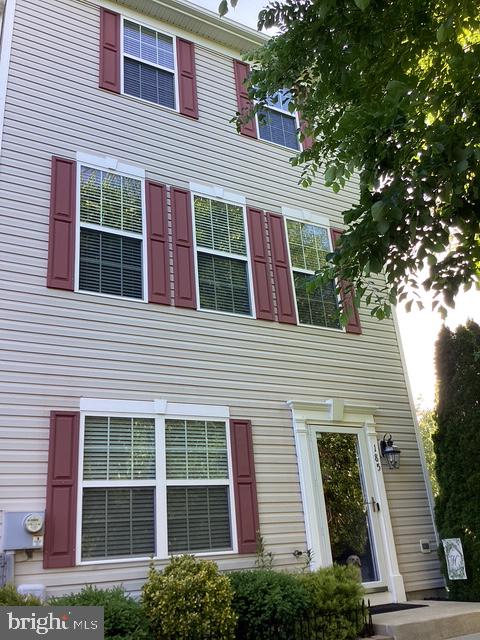 Welcome home to 185 Hopewell Dr., a stunning, contemporary end-of-row townhouse in the highly sought-after Charlestown Crossing community.  A charming front landscape, tree lined street and a community pergola frame this beautiful townhome!  As you step through the front door, you’re immediately greeted by a bright and inviting entryway. The first room you encounter is a flexible space—perfect for entertaining, use as a family room, home office, at home gym, etc.  It’s a versatile area that adapts to your needs. Next is the coat closet, an additional bonus/storage room that is plumbed to add a powder bathroom, and the laundry area with included washer and dryer.  The utility closet and the 2 car garage interior entry door complete this level.

As you continue upstairs, the home opens up into an expansive open-concept living area with a convenient half bath on this floor.  The eat-in kitchen is sleek and modern with stainless steel appliances, stone backsplash, quartz counters, large pantry, and two islands, one a central island that’s perfect for meal prep or casual gatherings. The adjacent dining area provides ample space for family meals or entertaining.  Head through the sliding patio doors to enjoy your morning coffee while relaxing on the rear deck. Moving to the upper level, the private areas of the home are found. The spacious owner’s suite is a true retreat, offering TWO large walk-in closets, a sitting area and a large en-suite bath with soaking tub, large stall shower, huge counter and vanity. Down the hall, you’ll find two additional rooms for use as secondary bedrooms or office space, and a second full bath. This meticulously maintained contemporary home is move-in ready and designed to impress. This is your opportunity to get it before its gone!