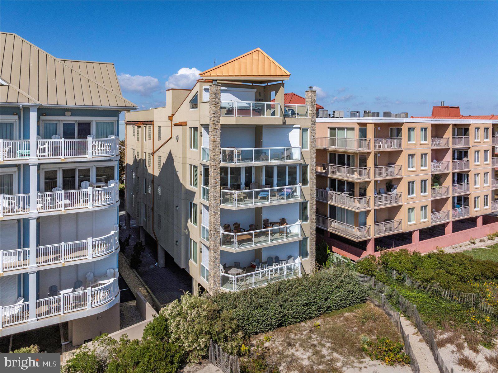 Luxury Direct Oceanfront 3BR/3.5BA Condo, 2,412 sq ft – Boutique Building with Only 4 Units! Experience the ultimate in coastal luxury living with this direct oceanfront 3-bedroom, 3.5-bath condo in one of Ocean City’s most prestigious boutique buildings. With only four residences, this exclusive property offers privacy, sophistication, and breathtaking views from every room. Wake up to the sound of waves and watch the sun rise over the Atlantic from your oceanfront primary suite, featuring private balcony access and a spa-like bath with a soaking tub and separate tile shower. The gourmet kitchen is a chef’s dream, boasting Viking appliances, custom cabinetry, a large prep area, and an elegant wet bar with wine storage—perfect for entertaining. The kitchen flows seamlessly into the dining area and spacious oceanfront family room, where a gas fireplace creates the ideal atmosphere for cozy fall and winter nights.
A wall of glass sliders opens to a private balcony overlooking the ocean—perfect for relaxing and soaking in the sound of the surf and the scent of the sea breeze. This stunning condo is sold fully furnished with high-end designer furniture, plantation shutters, and custom tile work throughout. Each guest bedroom offers its own en suite bath, providing comfort and privacy for family and friends. Luxury, elegance, and oceanfront tranquility await in this one-of-a-kind Ocean City residence. Enjoy the rooftop sundeck. Don't miss this unique opportunity.