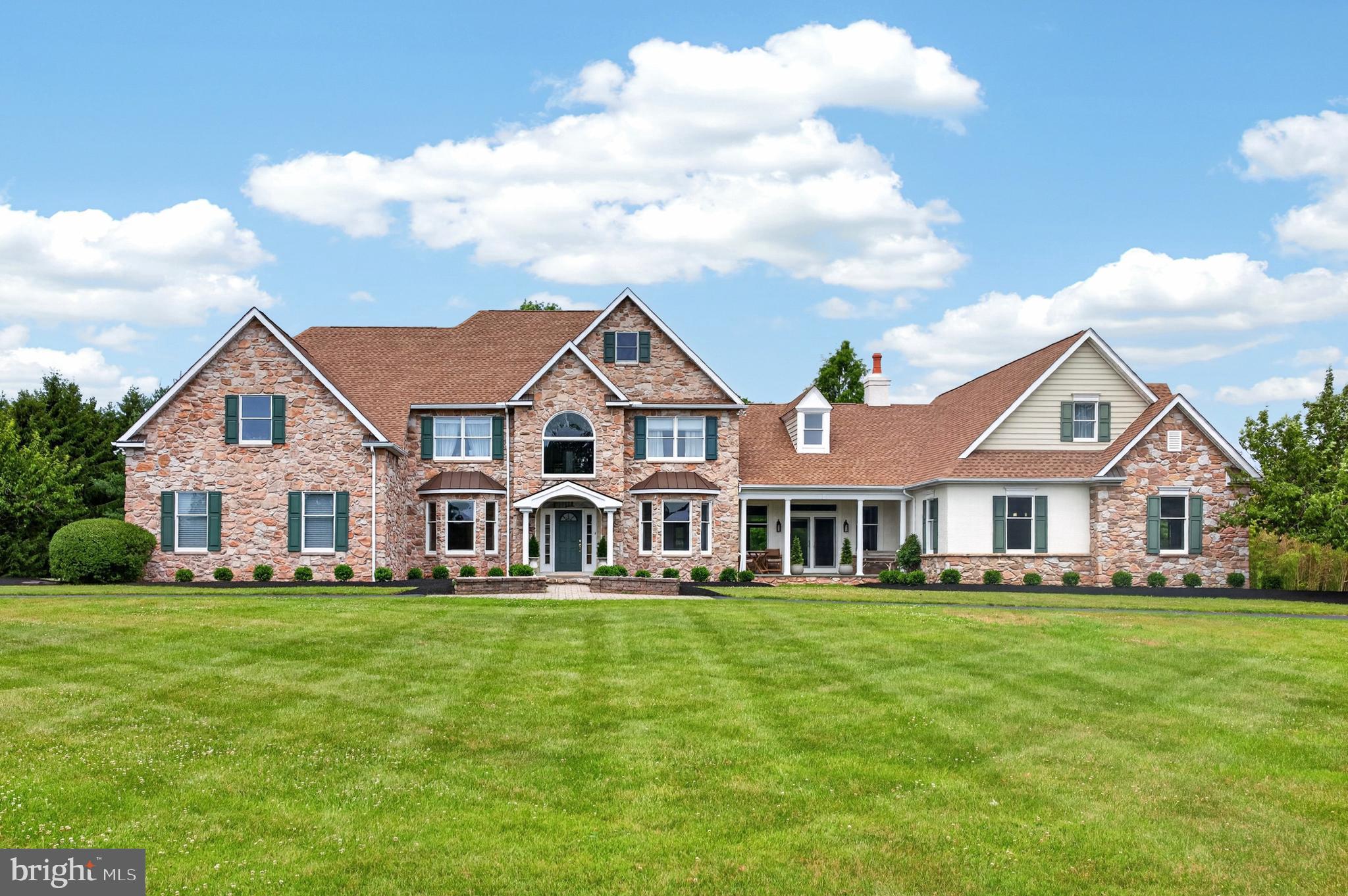 Welcome to this extraordinary estate in Collegeville, located within the highly acclaimed Methacton School District. Situated on 3 private acres, this impressive 4-bedroom home offers 3 full bathrooms, 3 half bathrooms, exceptional living space, and endless possibilities for entertaining, recreation, and luxury living.

From the moment you enter, you'll appreciate the beautifully finished hardwood floors adding warmth and timeless elegance. The main level is designed for both grand entertaining and everyday comfort, featuring a spectacular ballroom complete with a fireplace and custom bar—an ideal setting for hosting celebrations, holiday gatherings, and special events. Two dining rooms provide flexibility for formal entertaining or casual family meals, while the expansive living room showcases soaring 20-foot ceilings that create a bright, open, and dramatic atmosphere.

The upper level is highlighted by an impressive owner's suite that serves as a private retreat. This expansive space includes a separate sitting room, a luxurious en-suite bathroom, and a large walk-in closet. Three additional generously sized bedrooms and two additional full bathrooms—one private and one shared—complete the second floor.

The finished lower level offers an incredible amount of additional living space and is equipped with heating, air conditioning, and a half bath, making it ideal for a home theater, fitness center, game room, home office, or multi-generational living.

Outside, the property's 3-acre setting provides ample room for outdoor entertaining, recreation, gardening, or future expansion. Car collectors, hobbyists, and those needing extensive storage will appreciate the six garage bays, offering abundant space for vehicles, equipment, and workshop needs.

This remarkable property combines luxury, space, and versatility in one of Collegeville's most desirable locations, creating a truly unique opportunity to own an exceptional home.