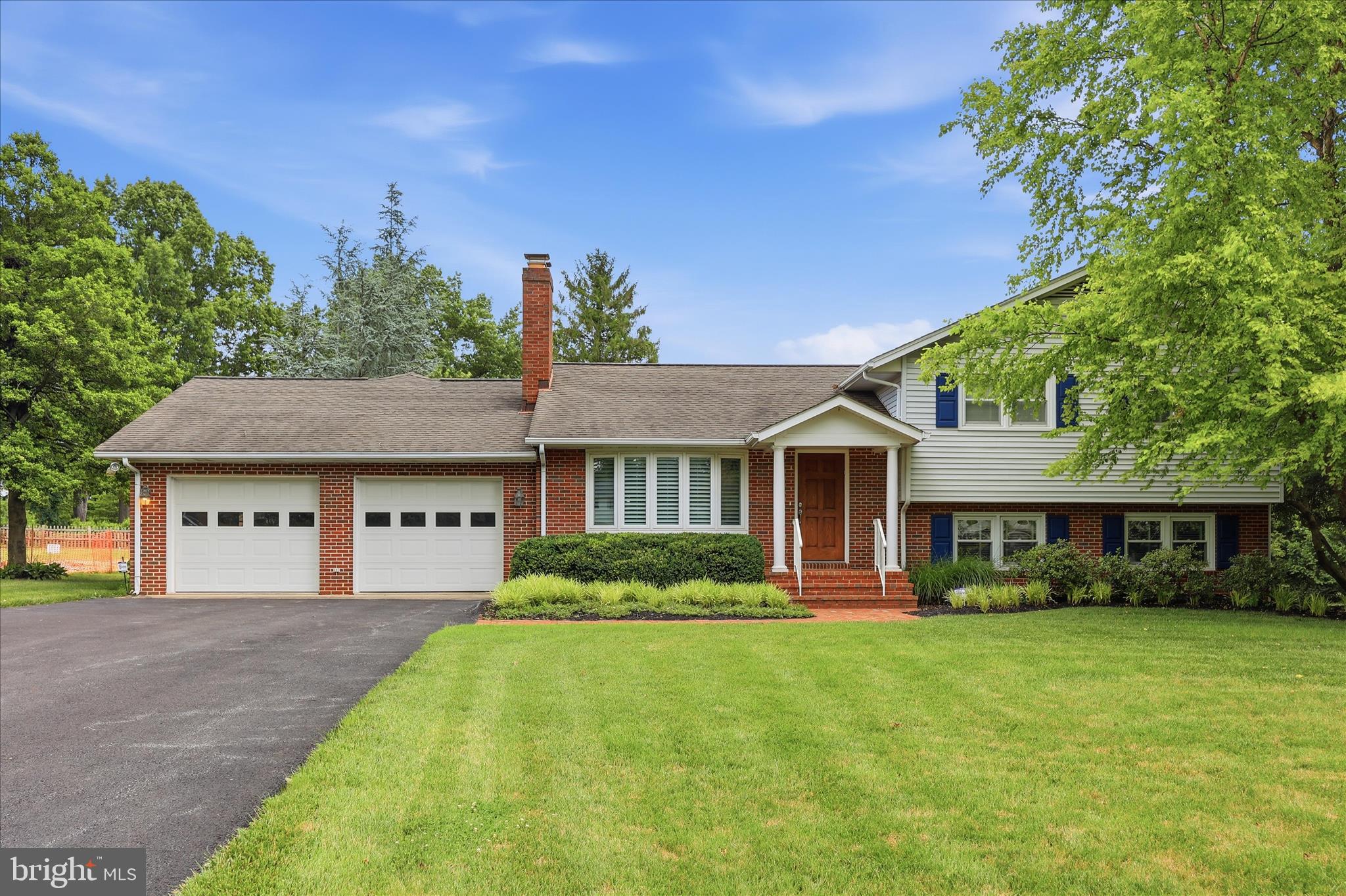Meticulously maintained and thoughtfully expanded, this exceptional Clover Hill home showcases the craftsmanship and attention to detail that made Ernie Ausherman homes so desirable—enhanced with beautiful updates, custom finishes, and truly move-in-ready living throughout.

Set on a beautifully landscaped lot with mature trees, this home has been lovingly cared for and expanded over the years to create a spacious and highly functional floorplan filled with character, quality, and thoughtful design.

Throughout the main level, beautiful hand-hewn hickory floors add warmth, character, and timeless appeal, setting the stage for the exceptional craftsmanship found throughout the home. The gracious dining room is highlighted by a large bow window and custom built-in display cabinetry, creating an elegant space for entertaining and showcasing treasured collections.

The heart of the home is the stunning custom kitchen designed for both everyday living and serious cooking. Beautiful white cabinetry features convenient roll-out shelving, a stand mixer lift, glass display cabinet, and abundant storage. Granite countertops, tile backsplash, prep sink, cooktop, range hood, double wall ovens, warming drawer, and a generous walk-in pantry create a space that is as functional as it is beautiful. A large picture window above the sink frames views of the lush backyard. Just off the kitchen is a striking blue-and-white tiled full bath and a convenient laundry room.

The kitchen opens seamlessly to an expansive family room where custom built-ins surround a propane gas fireplace, creating a warm and inviting gathering space. A wall of windows overlooks the private backyard and gardens, bringing the outdoors in. Throughout the home, custom plantation shutters add timeless style and elegance.

One of the home's most impressive additions is the luxurious primary suite featuring cathedral ceilings, large windows, a generous walk-in closet with custom organization system, and a beautifully updated ensuite bath with dual vanities, walk-in shower, and frameless glass enclosure. Two additional bedrooms and a second full bath complete the upper level.

The first lower level offers incredible flexibility with a spacious fourth bedroom large enough for a king-sized bed, a dedicated home office with built-in shelving, and a fourth full bath. The office opens directly to the screened porch, allowing you to enjoy the extensive landscaping, flowering shrubs, and peaceful surroundings in comfort.

Outdoor living is equally impressive with a screened porch, paver patio, level backyard, mature trees, and extensive landscaping that creates a private oasis. Adding to the sense of privacy, the original Clover Hill homestead borders the property, providing an uncommon buffer of green space to the side and rear with no neighboring homes looking directly into the backyard.

A second lower level provides additional finished space ideal for a recreation room, game room, hobby area, or fitness room, along with a large storage room complete with workbench.

Additional features include an oversized two-car garage, four full bathrooms, abundant storage, and countless custom details throughout.

Residents enjoy access to Clover Hill's community pool, parks, and walking areas, all while being conveniently located near shopping, restaurants, commuter routes, and downtown Frederick. Situated just outside the city limits, you'll enjoy all the conveniences of Frederick without city taxes.

Beautifully updated, meticulously maintained, and filled with custom touches throughout, this exceptional Clover Hill home offers the space, quality, privacy, and lifestyle that today's buyers are searching for—without a project list waiting when they move in.