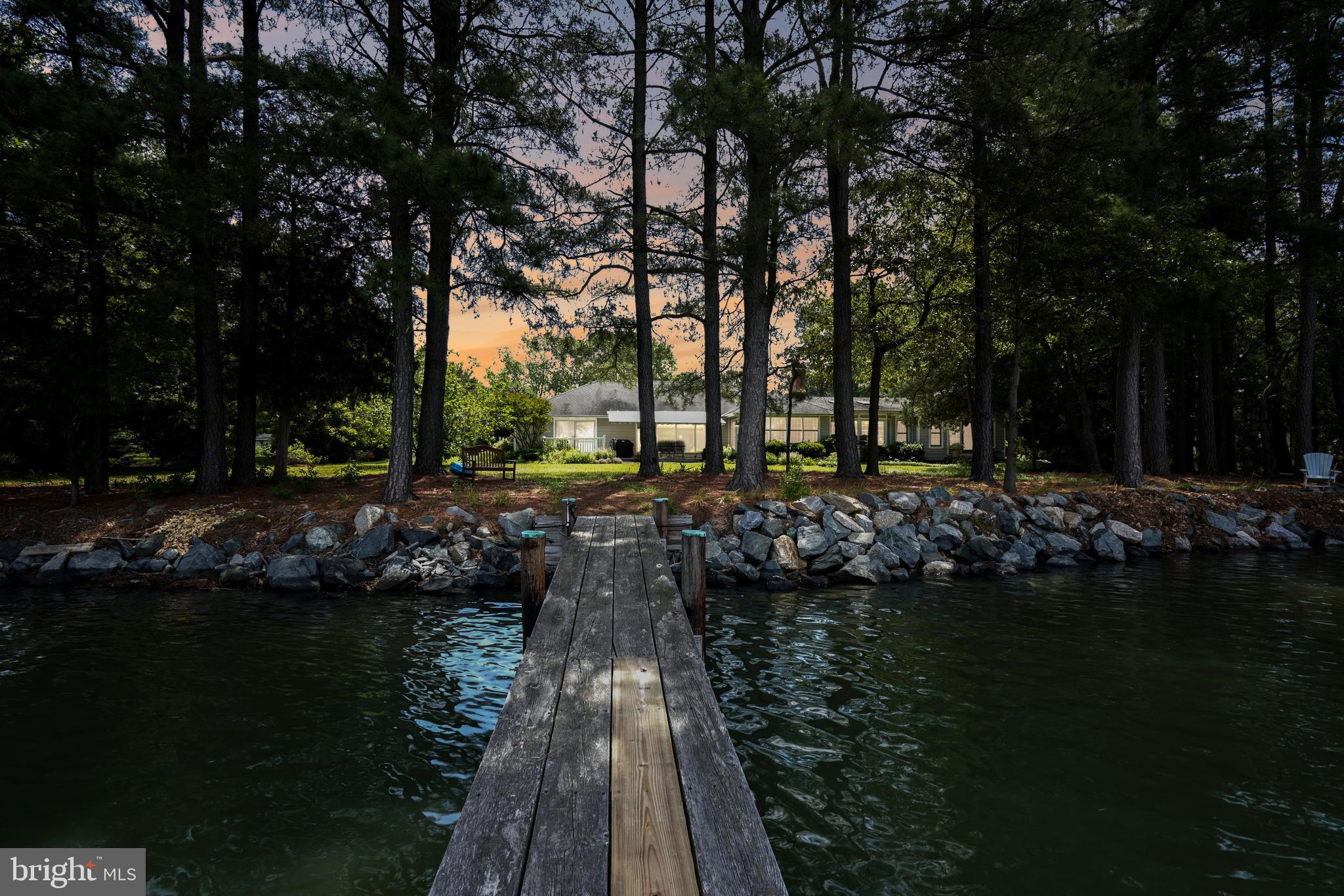 Welcome to the enchanting retreat of Irish ​Cove, where tranquil waterfront living meets ​timeless elegance. Nestled along the ​picturesque Irish Creek, just off the Choptank ​River, this one-level residence invites you to ​experience the epitome of luxury and ​comfort.

Spanning over 4,000 square feet, this ​residence boasts an expansive layout ​designed to capture the essence of waterside living. The moment you step inside, be captivated by the breathtaking water views that ​permeate the living spaces. The home features four generously appointed bedrooms, including two primary ​suites strategically positioned to offer stunning vistas of the surrounding landscape. Warmth and charm embrace you as you gather around the wood-burning fireplace in the heart of the ​home, creating a cozy ambiance that complements the scenic beauty outside. The spacious waterside ​living rooms, adorned with large windows, invite natural light to dance across the interiors, creating an ​atmosphere of serenity.

Step outside onto the expansive waterside deck, a perfect vantage point to savor the beauty of Irish Creek. ​The 2.74-acre lot provides ample space for relaxation and recreation, complete with a private dock for ​seamless access to the water. Imagine spending evenings on your dock, watching the vibrant westerly sunset views over the Choptank River. The property comes complete with an extra-large garage, offering both functionality and ​storage options. Additionally, a large shed and a beautiful fenced garden provide the perfect setting for ​outdoor activities and hobbies. Discover the harmony of luxury, nature, and waterfront living at Irish Cove.