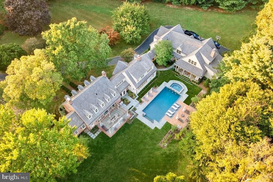 Welcome to a masterclass in luxury living. This truly unique gated property is ideally located in Willistown Township in the highly sought after Radnor Hunt area on 4+ manicured acres minutes from Main Line shops and restaurants.  Originally built in 1967, this spectacular Williamsburg Colonial has been elevated through two, no-expense-spared renovations: a 1991 architectural re-design by ChesCo Architect McIntyre/Capron & Assoc. w/ renovations by Steve Young, and a breathtaking 2021 top-to-bottom transformation by Baroni Building Co. and Liz Walton Home Design. This estate offers a seamless blend of timeless elegance and bespoke modern amenities. –An Entertainer’s Dream Interior– Step inside to discover site-finished, 7-inch wide-plank white oak floors flowing throughout the entire first floor, accented in a herringbone pattern in the custom wet bar area. Both main staircases have been replaced to match the elevated aesthetic. The true centerpiece is the gourmet kitchen crafted by Baroni Building Co. with bespoke cabinetry, imported Italian marble countertops, a Sub-Zero refrigerator, and a dual-oven 48-inch Wolf gas range. Elegance is in the details, like Signature Hardware faucets and solid brass cabinet hardware imported directly from England. The family room features a Regency Pro Series wood insert capable of heating the entire home. In the first-floor primary suite, the custom walk-in closet cabinets by Baroni have Italian marble tops, while the en-suite bath features marble floors and the bedroom itself has built-in closets and a woodburning fireplace. Lastly, beauty meets convenience in the fully custom mudroom with floor to ceiling cabinetry, alongside a renovated laundry room that includes a phenomenal elevated dog-washing station. Upstairs plush carpeting is found in all three bedrooms which each feature an en-suite bath. The second floor landing includes a hall bathroom, two built-in window desks with pendant lighting, a built-in day bed and a living space perfect for a children’s hangout, a study space or exercise room. –Spectacular Grounds & Outdoor Living–  Set on a magnificently hardscaped and landscaped lot designed by Finnerty LLC, the exterior is an absolute oasis. The resort-style pool, installed by Paradigm Distinctive Pools, is complete with a bonus heat pump for extended season enjoyment. Hobbyist touches include a predator-resistant chicken coop and garden area with shed, equipped with 3-season plumbed water. Meticulous exterior upgrades ensure lasting beauty and function. The original siding was upgraded with Azek trim. The cedar roof, replaced in 2005, was cleaned in 2020 and is routinely treated. –The Carriage House– Built in 2009, the exceptional Carriage House is a property unto itself. The first floor features hydronic in-floor radiant heat, a powder room and a state-of-the-art golf simulator. Accessible via a private elevator, the upper living quarters include a fully equipped kitchen with brand new quartz countertops and a Sub-Zero fridge, its own propane HVAC system and a new on-demand water heater. The large primary suite here has attractive dormer windows and hardwood floors and a full bathroom that is also accessible from the hall. A second bedroom is currently used as an office. –State-of-the-Art Systems & Peace of Mind– This home operates with total reliability and modern efficiency. The entire house was re-insulated in 2021. Power and technology are upgraded with 400-amp electrical service, a 4-year-old Generac liquid-cooled whole-house generator, seven exterior cameras, one garage camera, and five hardwired exterior access points. Climate control and plumbing systems are highly upgraded, featuring two electronically controlled, multi-zone oil-fired HVAC systems, two new water heaters (2020), and a 500-gallon buried propane tank. A brand-new 6-bedroom septic system with oversized seepage bed was installed by On-Site in 2020, and sewer lateral was replaced in 2019.