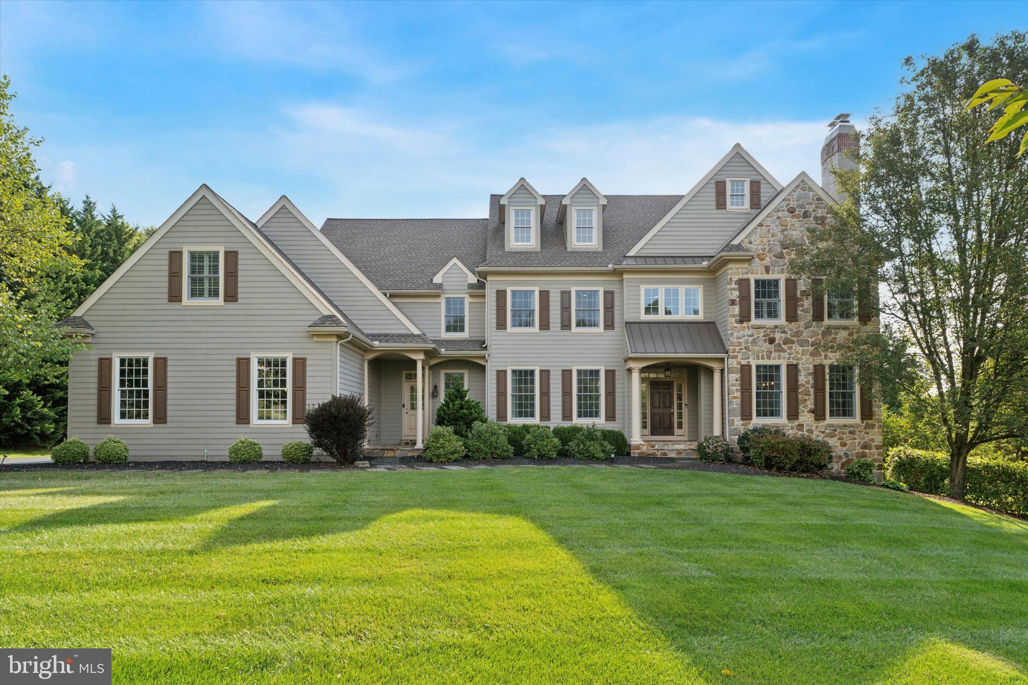 This stately home offers timeless curb appeal and a thoughtfully designed interior. Carefully maintained and enhanced over the years, it showcases quality finishes and elegant details throughout. The main level features a formal living room with a full masonry fireplace, a spacious dining room, and a custom office with built-in storage and a formal half bath, while the open-concept kitchen, breakfast area, and family room create the perfect space for everyday living and entertaining.

The kitchen remains a standout, with a generous island including a prep sink, classic bisque cabinetry, granite countertops, two dishwashers, a wine cooler, high-end appliances, a 52” built-in refrigerator, a gas cooktop, double ovens, and a warming drawer—ideal for any home chef. The adjoining mudroom, accessible from both the garage and a side entrance, includes travertine flooring, custom cubbies, and an additional half bath.

Upstairs, the primary suite offers a private sitting room, walk-in closets, and a spa-like bath with custom vanities, travertine flooring, and a large frameless glass shower. Four additional spacious bedrooms and three full baths provide plenty of room for family and guests. A second-floor laundry room, designed with custom cabinetry and hookups for two washers/dryers, adds both function and convenience.

The third-floor attic is fully framed with a full bath, offering the opportunity for additional finished space.

The finished walkout basement adds an impressive amount of living space with endless possibilities. A custom-built entertainment bar, multiple sitting areas, a fitness space, and a full bath make it ideal for both relaxing and entertaining. There’s also a separate kitchenette and an enclosed room that can serve as a playroom, guest bedroom, private office, or larger gym. With plenty of square footage and its own outside entrance, this lower level expands the home’s versatility in every way.

Outdoor living is equally inviting, with a travertine patio that overlooks the natural beauty of Chester County. Additional highlights include upgraded carriage-style garage doors, a newer water heater, and a grinder pump system.

All of this, just minutes from Kennett Square and West Chester, in the highly regarded Unionville-Chadds Ford School District—close to Unionville Elementary, Patton Middle, Unionville High School, and nearby recreational fields. Schedule your private showing today.