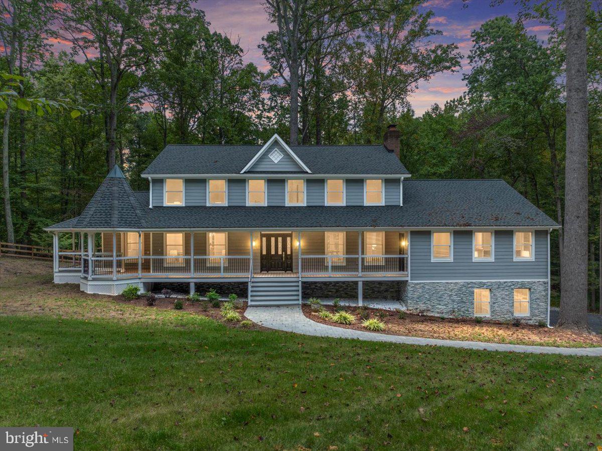Discover tranquility in this exceptional 5-bedroom home, nestled on a serene 5-acre, park-like lot in the highly desirable Great Falls community. This residence offers a perfect blend of luxury and comfort with high-end European finishes and a thoughtfully designed floor plan. The main level features a primary suite with an attached sitting area or office, providing ultimate convenience and privacy. The gourmet open-concept kitchen is equipped with top-of-the-line Bosch appliances, elegant quartz countertops, and sleek Hacker cabinets, making it a chef's dream. Throughout the home, you'll find exquisite craftsmanship, including Iris Italian tile, Grohe plumbing fixtures, and engineered wide plank blonde hardwood floors.
The light-filled lower level is perfect for entertainment, with a home theater, an additional bedroom, gym space, and ample storage. Outside, relax on the large Trex deck or wrap-around porch, both offering breathtaking views of the surrounding woods—a true nature lover’s paradise. The upper level offers four spacious and well-appointed bedrooms, ideal for family or guests. There is also an unfinished loft space on the fourth level, perfect for creating a private den, home office, or additional living area. An oversized three-car garage provides plenty of room for vehicles and storage. This home is part of the Langley High School pyramid, ensuring top-rated education opportunities. With unmatched privacy and serenity, this home is still conveniently located near shopping and dining.