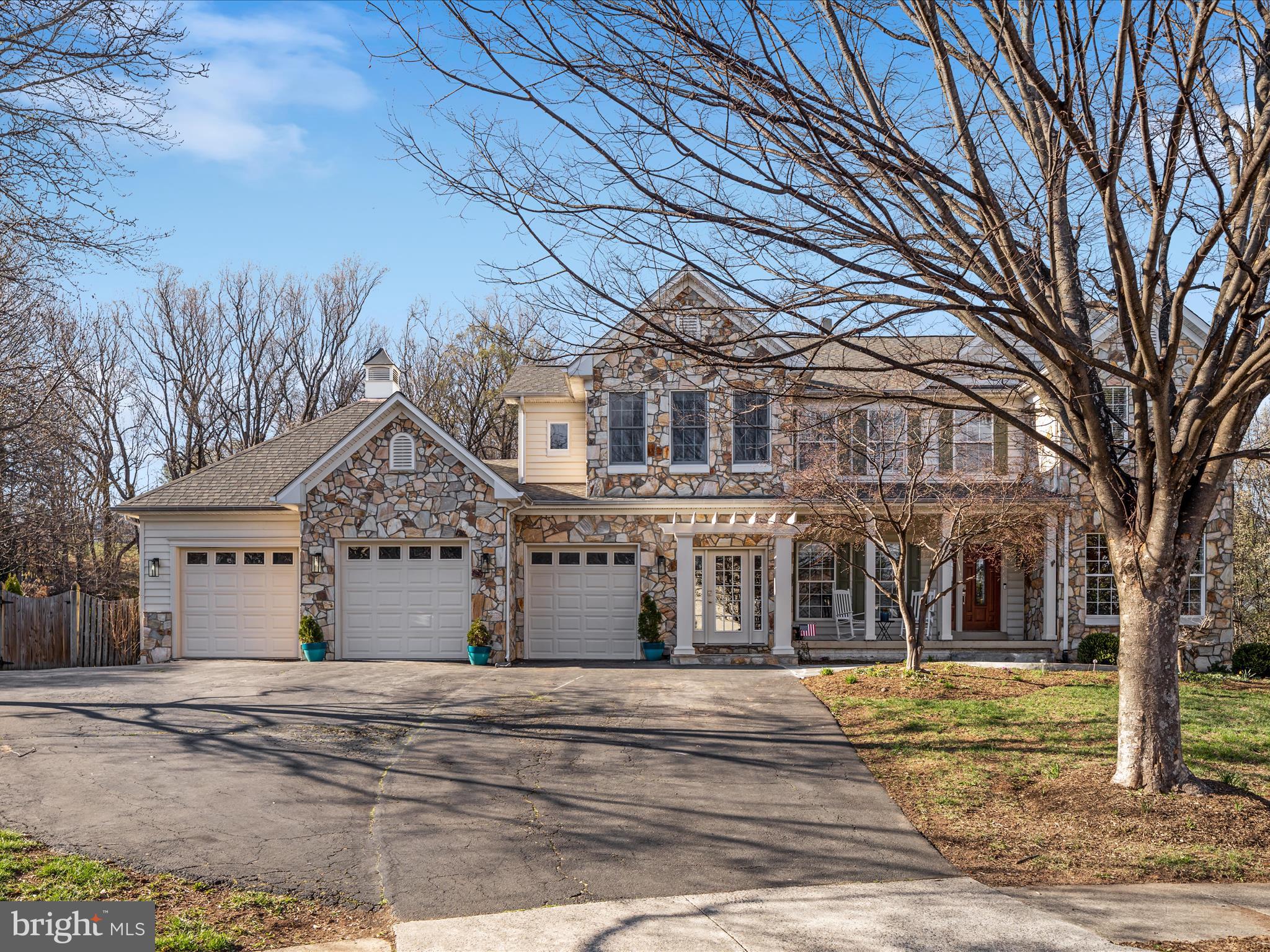True "forever" home with main level primary suite and multi-generational options with lower level in-law/au-pair suite with second kitchen and full bathroom!!! Gorgeous and impressive stone front elevation beauty in the desirable Old Waterford Knoll community. Nestled at the end of a cul-de-sac and sitting on almost an acre of ultimate privacy with a magnificent freeform, private pool with diving board that will leave you the envy of the neighborhood. An epically picturesque setting, feels like your own private resort. What a combination of privacy, amenities, and convenience this close to downtown Leesburg! This home boasts a beautiful front porch and classy separate front mudroom entrance. Oversized 3 Car Garage  with window and access to pool bathroom! Inviting foyer leads to an elegant and open floor plan with a grand 2-story family with stunning floor to ceiling brick wood burning fireplace. Main level office with built-in bookcases, cabinets and stylish pocket doors. Eloquent trimwork everywhere including crown molding, shadow boxing and chair rails. Receiving room with leaded glass pocket doors. Large formal dining room with beautiful bay window and immense light to enjoy those family gatherings. Convenient and tucked guest bathroom on main level. Stunningly remodeled in 2024 high end kitchen with all the bells and whistles overlooks
the family room. Gorgeous white kitchen with huge soapstone island with breakfast bar,
open shelving, incredible, thoughtful details everywhere including intentional coffee bar
station with built in key storage cabinet, wine fridge, huge pantry, stainless steel
appliances, separate three stage water filtration faucet, pull outs and soft close cabinets
and French doors leading out to fabulous screened in porch with fan that opens to a
large open deck and two stairs down to flagstone patio and oversized pool. Mudroom
and laundry room with separate front entrance and stunning tile with access to garage,
storage closet, built in cabinets, newer whirlpool washer and dryer 2020 and second
refrigerator. Incredible and highly sought after true primary suite on the main level in a truly tucked, private and phenomenal location. Prepare for the newly remodeled 2021 primary suite to absolutely blow you away. Grand and impressive primary with 2 skylights, private sunroom feel sitting room with floor to ceiling windows and gas fireplace, grand and gigantic shower with double shower heads, rain shower, built in cubbies, separate his and her counters with soft close cabinets, double walk in closets, and private French doors out to deck and pool. Pool bathroom with access off deck or through garage. Second, back staircase past primary suite up to office loft or au pair suite with full bathroom and closet. Expansive and elegant bright and spacious walk out basement with recreation room full bathroom, complete in-law suite with private access to full bathroom, wet bar/kitchen with gorgeous streaked white, quartzite counters and open shelving with dark and beautifully contrasting dark cabinets. 3 additional unfinished storage spaces. Beautiful and mature landscaping with walnut, maple, oak, redbud, dogwoods, paw paw, river birch, ironwood, sweetgum, magnolia, sycamore, tulip poplar, honeysuckle, an abundance of flora and fauna. Both HVAC's new 2017. New carpet 2025. Pool filter system 2021. Complete kitchen renovation 2023.
