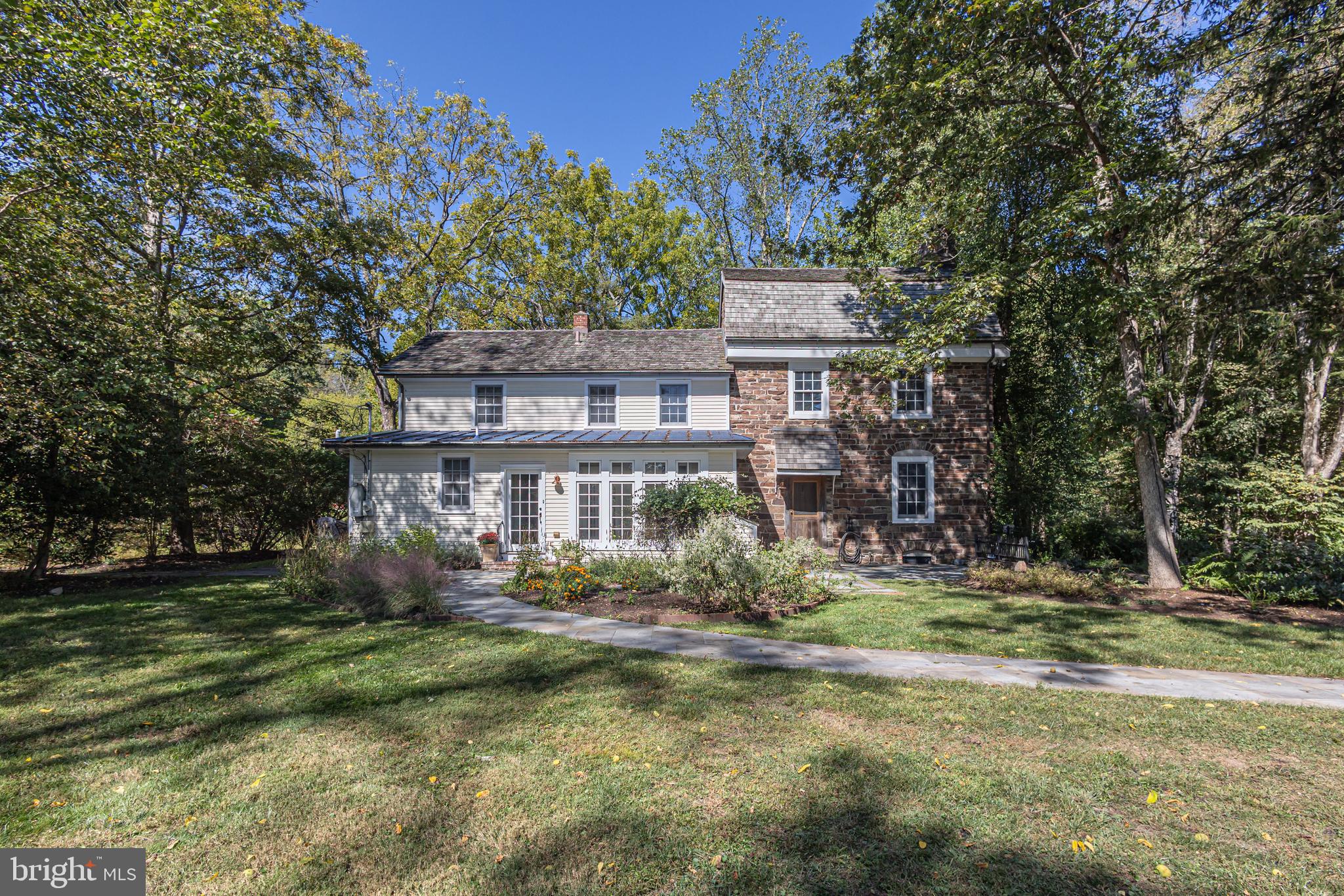 Vintage farmhouse with entertaining barn! Presenting the Matthias Harvye Estate, one of Bucks County’s most exceptional historic estates. Situated on three acres between the Delaware River and the Canal in Washington Crossing, this property represents a rare opportunity to own a significant piece of history. Upon entering via the distinctive red bridge over the canal, visitors are greeted by an atmosphere that reflects the property's storied past; historical records note that General Washington and his troops camped on these grounds prior to their march to Trenton.  The Canal House residence  originally constructed in 1709, has been thoughtfully updated to incorporate modern conveniences while retaining its period character. The home comprises 3 bedrooms and three and one-half bathrooms, featuring authentic hardware, pumpkin pine flooring, pie staircases, deep sill windows, and two fireplaces, complemented by amenities such as heated floors, walk-in cedar closets, and contemporary lighting. The estate also includes a second residence: a restored barn house, dating back to circa 1840 and relocated from Kutztown, Pennsylvania. This barn home offers three bedrooms, all ensuite, plus a full pool bathroom. It is equipped with a gourmet kitchen, complete with premium stainless-steel appliances, soapstone countertops, and cabinetry fashioned from reclaimed barn wood. Expansive ceilings and large windows create a bright, open environment, while wide plank floors and two prominent turned staircases enhance the interior. Noteworthy architectural details include Moravian tile mosaics and accents throughout. Outdoor features comprise of a rectangular inground pool surrounded by landscaped gardens and paver patios, as well as a covered three-season entertainment area constructed from the original barn stone walls, a substantial stones fireplace and a fire pit, with tranquil patio setting. The 1800’s springhouse is equipped with heating and cooling and has been converted into a gym on the first floor and a wine cellar in the basement.  Further amenities include a three-car detached garage with epoxy flooring and integrated storage, a custom pond populated with frogs and fish, back-up generators for both homes, direct access to the canal towpath, and proximity to historic Washington Crossing State Park, the Delaware River, and nearby towns such as Newtown, New Hope, and Yardley for dining and shopping. Professionally landscaped grounds with a custom night-time lighting system and meticulously maintained walkways lined with vibrant flowers all add to the estate's appeal.  Combining historical importance with contemporary comfort, the Matthias Harvye Estate presents a distinctive lifestyle opportunity in Bucks County. So, cross the red bridge and let this extraordinary property capture your imagination.