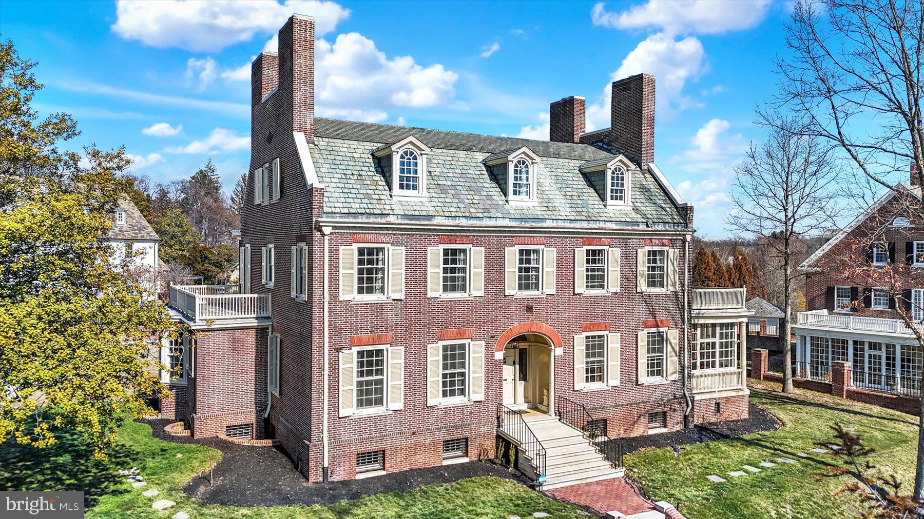 Perched high above the street behind elegant iron gates, 818 W University Parkway is a truly exceptional brick property offering over 7,000 finished square feet of timeless architecture and modern comfort. Situated on more than half an acre of beautifully landscaped grounds, the property is fully enclosed by brick walls and wrought iron, delivering a rare sense of privacy and presence in one of Baltimore’s most iconic settings.
A stately façade with dormer windows and multiple chimneys hints at the extraordinary craftsmanship found throughout. Inside, the home features six bedrooms, six full bathrooms, and eight fireplaces, with gracious rooms designed for both everyday living and large-scale entertaining.
The main level features expansive formal rooms, remarkable architectural detailing, and a stunning sunroom filled with natural light overlooking the grounds. At the center of the home is an expanded gourmet kitchen, complemented by a full scullery with dual ovens and a separate breakfast room—ideal for both everyday living and entertaining.
The second floor offers four spacious bedrooms, each with its own fireplace, along with a private study and two bathrooms on each side of the floor, creating a flexible layout well suited for guests, home offices, or family living.
The primary suite, occupying the entire third floor, serves as a true private retreat rarely found in historic homes. A comfortable sitting room leads to the spacious bedroom and a large primary bathroom featuring dual sinks, a soaking tub, oversized walk-in shower, and an expansive bonus room perfectly suited for a dream walk-in closet or dressing room.
The finished lower level with rear entrance offers ideal flexibility for an au pair suite, guest quarters, gym, or additional family room.
While rich in historic character, the home has been thoughtfully updated with modern infrastructure including:
• Dual-zone high-velocity HVAC system (5-ton attic unit and 3.5-ton basement unit)
• Two new 50-gallon hot water heaters
• 400-amp electrical service upgrade
• Whole-home water purification system
• Smart circuit panel with battery failover for power outages

A rare opportunity to own a grand Baltimore property where architectural detail, scale, and craftsmanship cannot be replicated today.