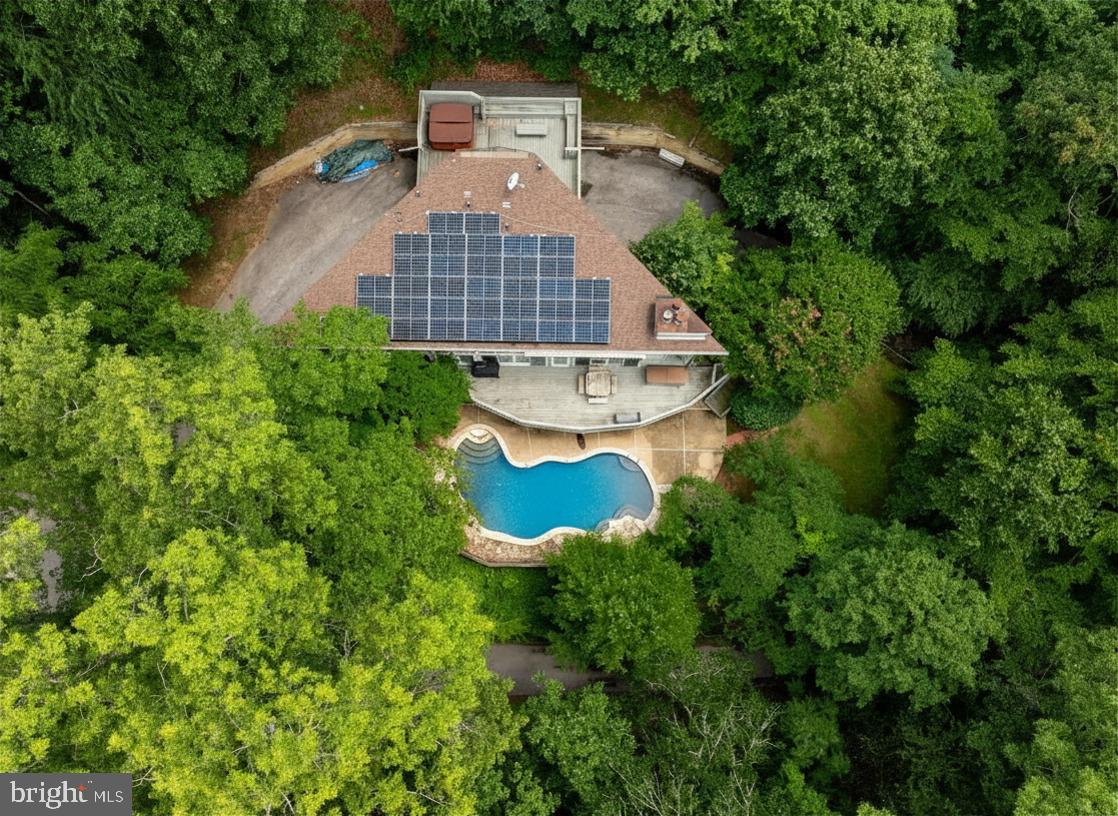 Experience nature at its finest in this custom-built Sparks retreat.  The unique layout is flooded with natural light and designed for true relaxation.  The kitchen has beautiful 48" solid wood cabinets highlighted by the custom transom windows that tell a story of sunrise to sunset.  This home features a massive deck overlooking the patio and pool, wood‑burning fireplaces on every floor. The large Owners Suite boasts cathedral ceilings, atrium windows, and a private deck with hot tub. The lower-level walks out to the fenced patio pool area.  This is a fabulous chance to own a home that truly feels like a year around vacation.  Dual HVAC units.  Conveniently located to Hunt Valley,  York Road and I83.
