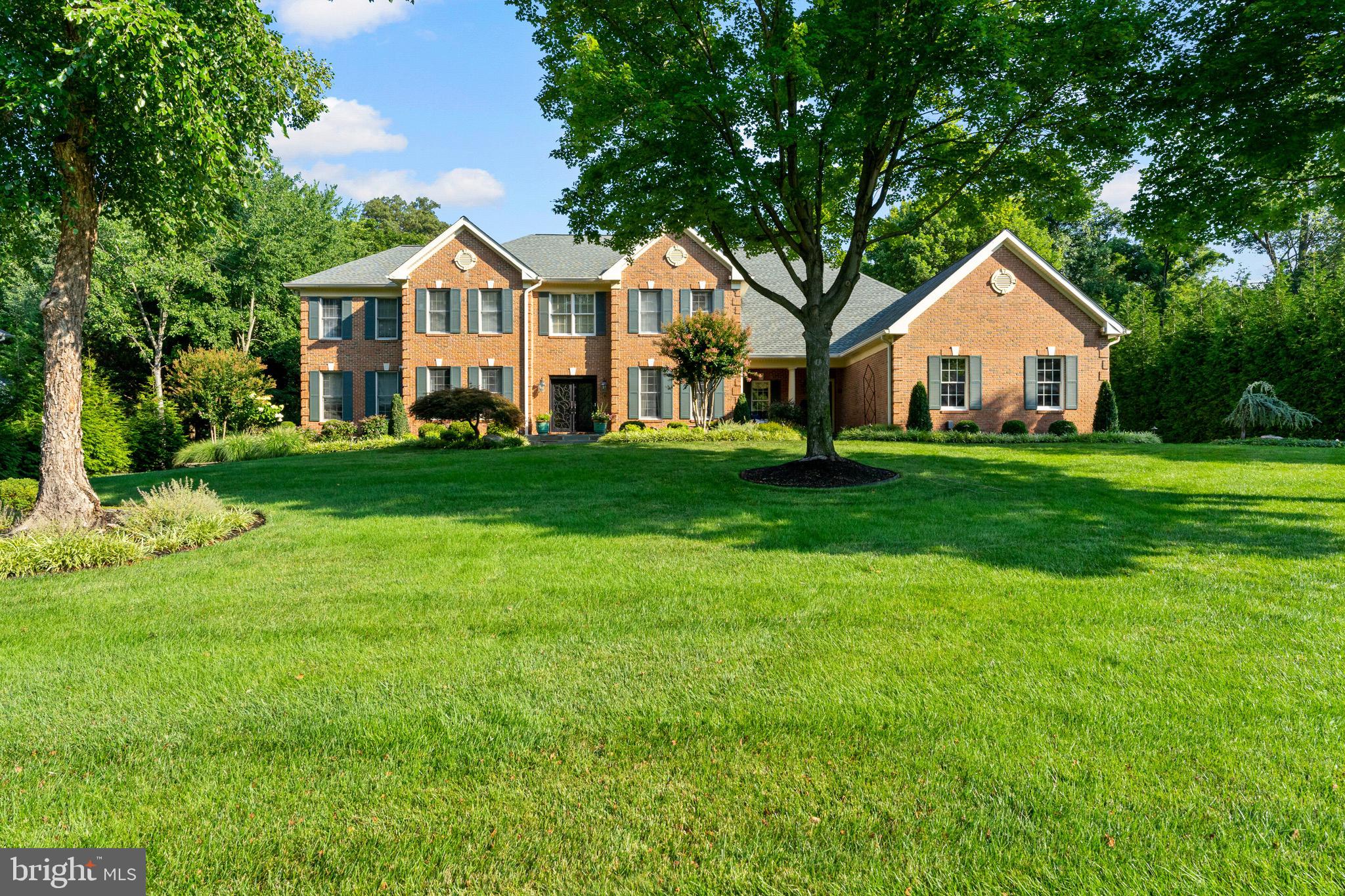 Discover unparalleled luxury in this luxurious 7 bedroom, 7.5 bath stunning brick estate, situated on a superbly landscaped lot in Oakton Chase, a premiere community in popular Oak Hill.  Just under one acre backing to trees w/custom lighting & irrigation system, the sought-after setting is a rare find.  The heart of this home is the kitchen addition complete w/dual islands for prep & entertaining, commercial grade appliances including a Viking 6 burner + griddle, double oven gas range, 72+ Thermador refrigerator w/ double drawer freezer, 2  additional freezer drawers, 2 dishwashers, built-in microwave & warming drawer, built-in, commercial-grade pizza oven, Travertine heated flooring, Downsview custom maple cabinets, honed granite & distressed walnut countertops, custom lighting & expansive dining area that offers both formal & informal entertaining options.  This kitchen addition was featured in the USA Today 2012 Home Magazine.  Choose from a main level or upper level master suite because this home has both! A floor plan conversion took place in 2020 and the fabulous main level master suite was designed to offer a sitting area/office with custom built-ins plus breakfast bar w/beverage refrigerator, two-sided gas fireplace, extraordinary master bedroom design w/custom built-ins & lighting, spa-quality bathroom showcasing a built-in soaking tub w/ jets, walk-in steam shower, dual sink areas & private full-size washer & dryer.  A Juliet door overlooks the breathtaking pool & exterior entertaining area.  You will also find enjoyment in the family room just off the kitchen, its beautiful coffered ceiling & stunning features including a stone faced, wood burning fireplace w/gas line for future conversion if you desire, recessed lighting & bar w/wine cooler.  From the time you enter the main door of this property, you can't help but love the formal dining room where so many memorable dinner traditions will be created.  Notice the phenomenal stack-stoned wall between the dining & family rooms.  The powder room is tucked into a private part of the floor plan.  The main level hardwoods were refinished in 2020.  The upper level boasts the 2nd & original master suite which features a spacious bedroom, sitting room w/gas fireplace & luxury bath w/dual sinks, soaking tub w/jets & walk-in shower.  Enjoy & eagerly fill the 2 large master closets w/custom organizers, one of which was extended in 2015.  You will find 4 additional large bedrooms on the upper level, each w/recessed lighting, private full bath & generous closet space w/organizers.  Need a late night snack?  No problem, you can sneak down the back staircase to the kitchen.  The lower walkout level features a sprawling rec room w/beautifully designed custom bar featuring a beverage refrigerator, microwave, built-in ice maker & dishwasher.  Sit by the gas fireplace  for movie night or utilize the additional space for various games as this owner has.  You will find the 7th bedroom on the lower level plus a full bath, yoga/exercise room, extensive storage and an artist room.  Why leave your home when you have an outdoor entertainment haven like this extraordinary property?  Exit from the kitchen to a spacious deck overlooking the rear yard & pool area.  Take the spiral staircase down to the ground level.  The fenced rear yard offers a custom pool w/diving board, hot tub, multiple entertaining & relaxation areas, shed, volleyball or game area among the lush landscape & custom outdoor lighting.  Under the extended kitchen is a large storage room that offers a refrigerator & sink for easy outdoor entertaining plus additional storage opportunities.  Did I forget to mention the 3 car side load garage with long driveway for additional parking?  Oak Hill is conveniently located to Reston, Fair Lakes & Fairfax Corner for many dining, shopping & entertainment options.  IAD, Innovation Center metro stop and W&OD trail are just a short drive.  A marvelous place to make your future home!