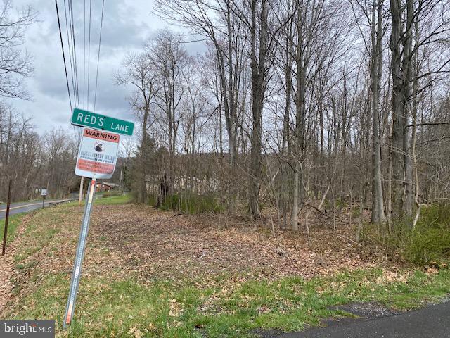 15 +/- wooded acres with a small pond. Public water hookup available. This property has not be perked.
