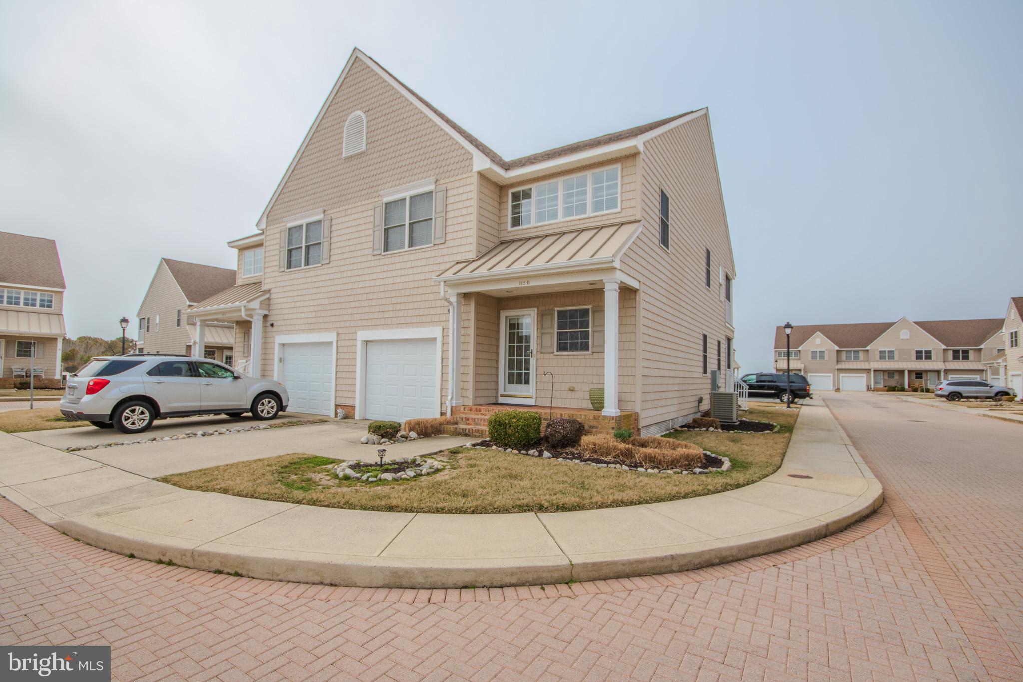Welcome to 112-B Sunset Cir in Crisfield! Experience the best of coastal living in this beautiful 3-bedroom, 3.5-bath end-unit home offering space, flexibility, and incredible community amenities. Perfectly positioned just steps from the water, this property includes your very own boat slip only a short walk away. This makes it effortless to spend your days out on the bay! Inside, the home features a bright open-concept layout that seamlessly connects the kitchen, dining, and living areas. Ideal for both everyday living and entertaining. A standout feature is the entry-level bedroom suite, complete with a walk-in closet and private full bathroom, providing comfort and convenience for guests or multi-generational living. Upstairs, you'll find the spacious primary suite, designed as a true retreat with a cozy seating area and a walk-in cedar closet with a closet system. The ensuite bathroom includes a soaking tub, separate glass-enclosed tile shower, double vanity, and private water closet. The upstairs loft/flex space offers endless possibilities; perfect for a 4th bedroom, playroom, office, or additional family living space. Step outside and enjoy low-maintenance, maintenance-free living with no yard work required. Directly across from your front door is the community in-ground pool, making it easy to relax and unwind. The neighborhood also features a community beach, playground, pier, and your private boat dock/slip, creating the ultimate waterfront lifestyle. This is coastal living at its finest! Schedule your private showing today.