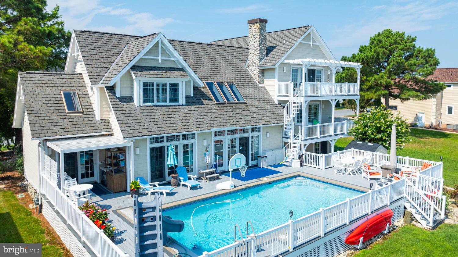 Welcome to your dream waterfront home in the desirable Terns Landing section of Ocean Pines! This exquisite 4 bedroom, 4.5 bathroom residence offers an unparalleled combination of luxury, comfort, and convenience, ensuring a lifestyle of relaxation and elegance. Each of the four bedrooms is ensuite, providing ultimate privacy and comfort for all family members and guests. The gourmet kitchen boasts granite countertops and updated stainless steel appliances, including a convenient wine fridge. A loft and separate bonus room provide ample space for a home office, playroom, or additional living area. Custom window treatments throughout add a touch of sophistication and privacy. Enjoy the updated Gunite and tile in the sparkling pool, complete with a brand new electronic pool cover for safety and convenience. Multiple decks offer stunning water views, perfect for entertaining or simply relaxing. The outdoor kitchen area is ideal for alfresco dining, and the outdoor shower is perfect for rinsing off after a swim. The modern bulkhead is only 2 years old, ensuring stability and peace of mind and includes a 12,500 LB boat lift! Additional amenities include an elevator shaft ready for installation, a garage with plenty of storage space, an extra refrigerator, and a new ice maker. An outdoor storage shed provides extra space for all your outdoor equipment. This waterfront home is a true gem, blending luxurious indoor features with exceptional outdoor amenities. Located in the vibrant Ocean Pines community, you'll have access to multiple pools (both indoor and outdoor),  Beach Club, Yacht Club, restaurant, children's programs and play area, a golf course, and more! With its updated finishes and thoughtful design, this home offers everything you need for a comfortable and stylish waterfront lifestyle. Don't miss the opportunity to make this stunning property your own! Call today for more information or to schedule a private showing.