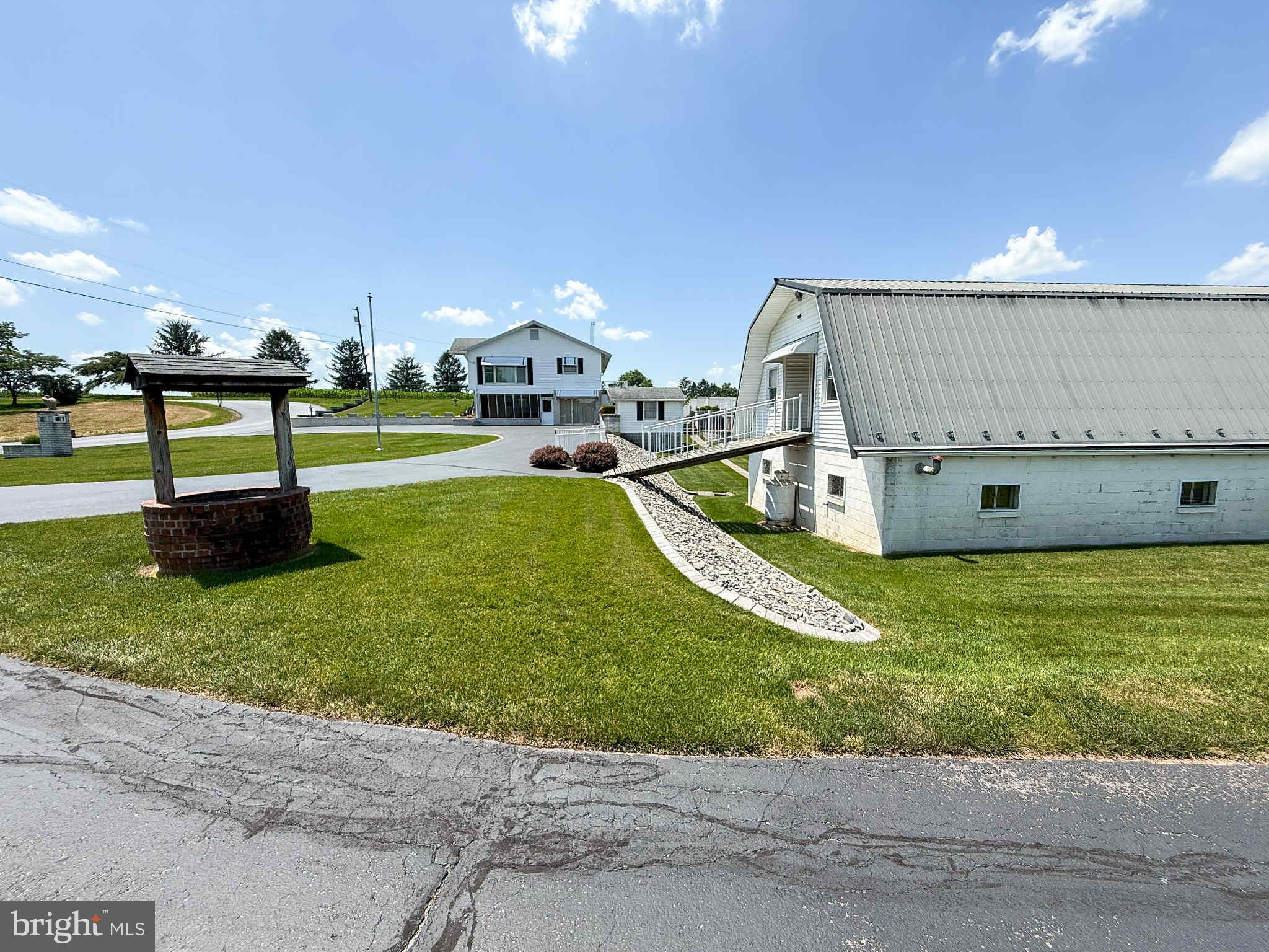 Discover this charming 3-bedroom, 2-bath home set on approximately 1 acre, offering scenic views of the surrounding farm fields. Located in the Greencastle school district, this property blends comfort, practicality, and peaceful rural living.

The home features 3 bedrooms and 2 full bathrooms, though there are numerous possibilities within the other spaces of the home. The lower level features a corner fireplace, laundry room, and recreation space, complete with a pool table that conveys! The main living space features a large living room with a floor-to-ceiling window, which offers lots of natural light! 

Outside, a curved driveway leads you to multiple outbuildings with endless potential. Near the home sits a smaller detached garage, while farther down the property, you’ll find a spacious 26x40 two‑story shop complete with an attached garage, interior workspace, plumbing with a sink, and an upper level that has been improved and is accessible by a ramp from the main driveway. Additional highlights include a detached metal carport with roof and side panels, plus plenty of open yard space.

This is a wonderful opportunity to make a versatile property your own.

**** Listing photos are from a previous listing when the home was vacant. The property is currently occupied, though the sellers are in the process of moving. ********

The pool is inoperable, and the seller has begun filling it in. Property is sold as‑is. DO NOT ENTER THE PROPERTY WITHOUT A CONFIRMED APPOINTMENT!