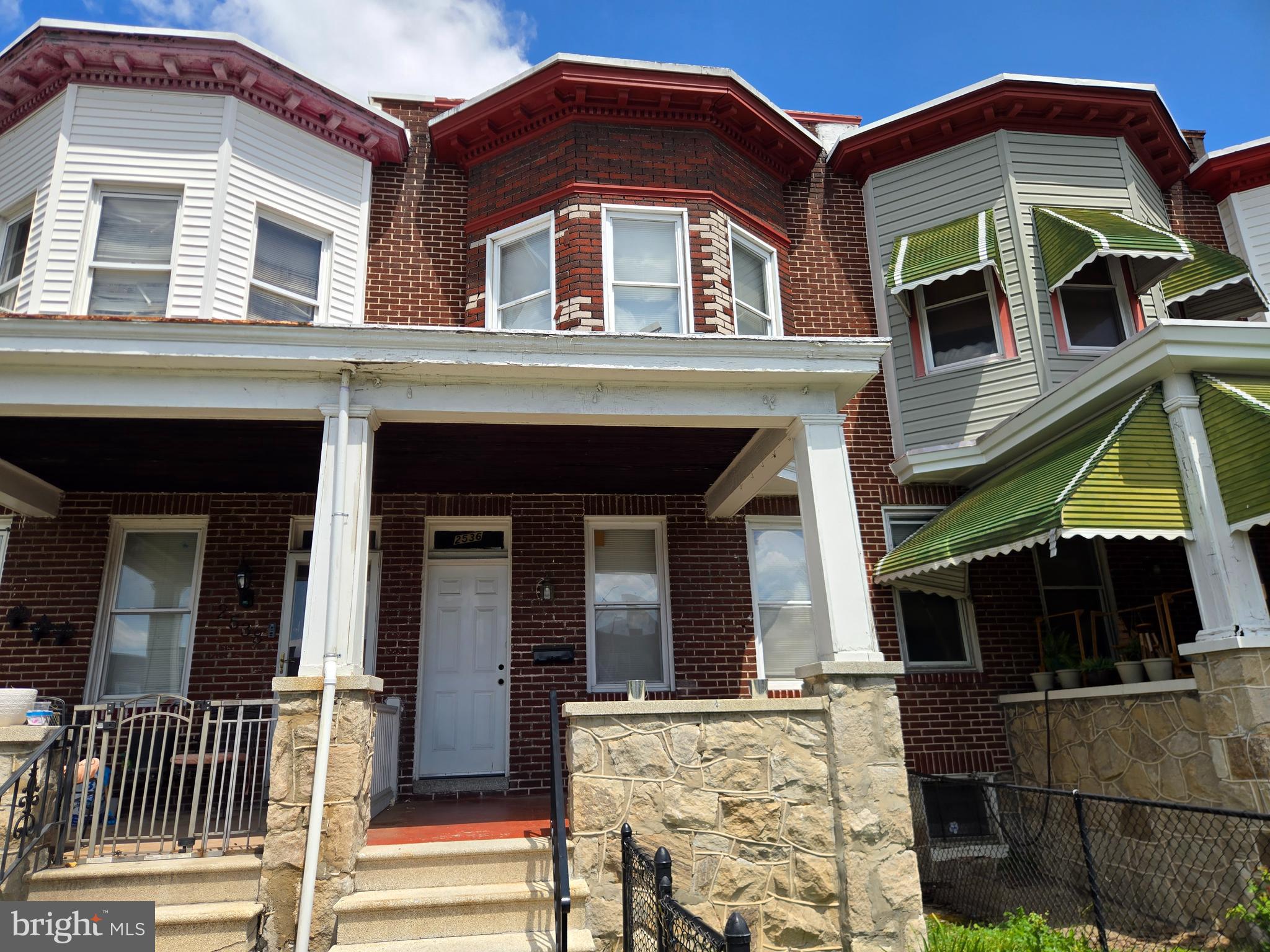 Spacious three bedroom and two full bath brick townhome  features a huge covered front porch and a rear one car garage. The home features an updated kitchen and bathrooms and is in good condition. Stunning woodfloors throughout.