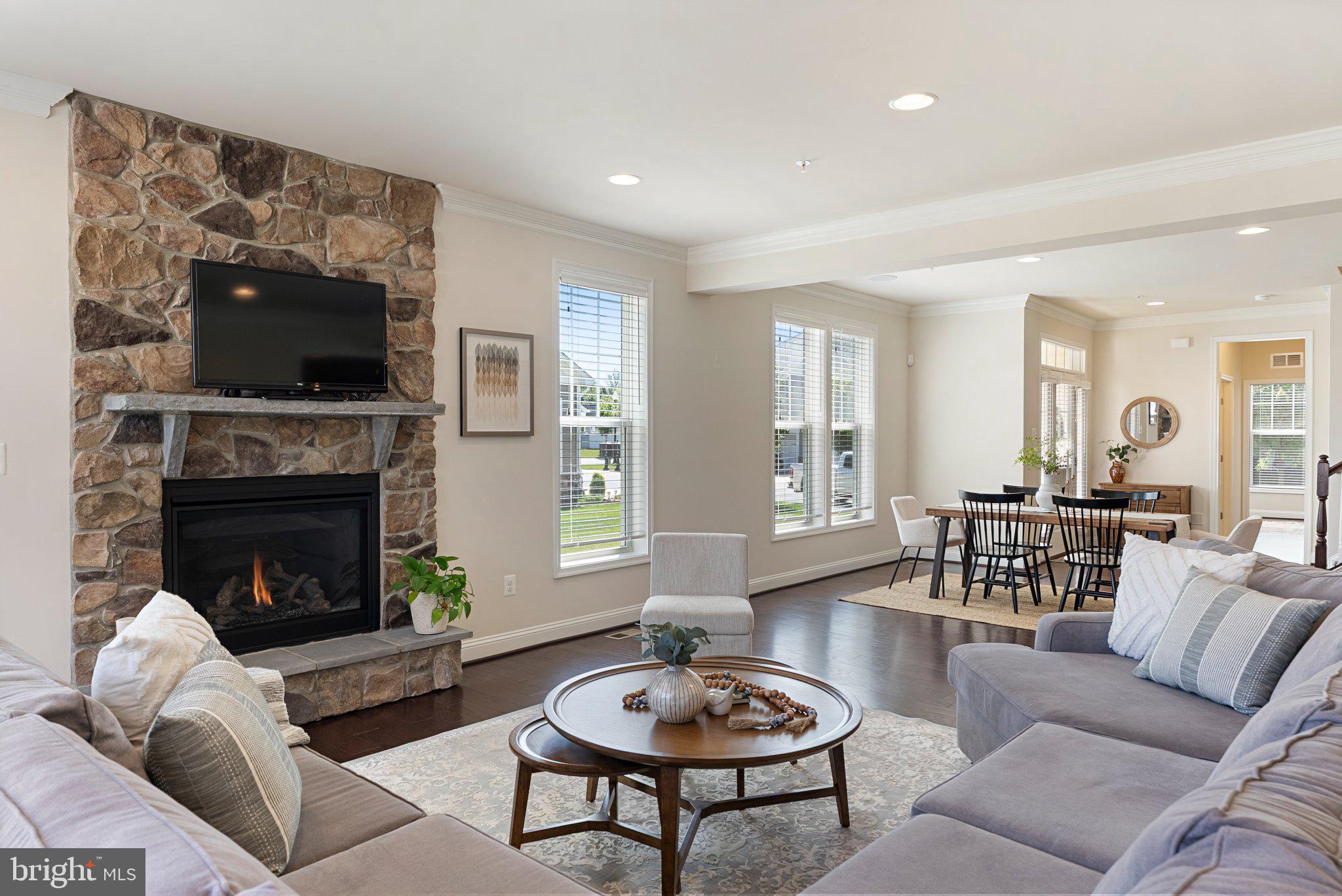OPEN HOUSES:  SAT 6/27 (10AM-12PM) & SUN 6/28 (1PM-3PM) 
Sunny and spacious "Carriage" home which offers the ease of upscale, low-maintenance living in the highly sought-after 55+ community of Two Rivers. Properties like this are rarely available and highly desirable for their unique appeal. Thoughtfully designed for comfort, convenience, and active adult living, this exceptional and economical home offers beautifully finished living space perfect for those ready to enjoy life without the burden of constant upkeep.
This four-bedroom, four-bath Carriage Home, was built by the highly respected Classic Group Builders and is known as one of the most sought after models, the “Vivian Model.” It features over $75K of premium upgrades, abundant natural light, and luxurious finishes throughout. The main level is designed for easy single-level living and includes a spacious primary suite with a spa-inspired bath, dual vanities, and an oversized walk-in closet. The open-concept layout creates a warm and inviting atmosphere with 9-foot ceilings, elegant living, dining spaces, and a dedicated home office for added flexibility. Additional conveniences include an interior entrance to the kitchen from the attached garage, laundry room with an energy-efficient washer, dryer and utility sink. 
The gourmet kitchen is sure to delight anyone who enjoys cooking or entertaining. Granite countertops, a large center island, stainless steel appliances, hardwood floors, and custom cabinetry provide both beauty and functionality for everyday living and special gatherings. Unwind on the paver patio with a comfortable sitting area, perfect for cookouts, casual gatherings, and getting to know the community’s welcoming neighbors.
Upstairs, guests will appreciate their own private retreat featuring a spacious bedroom, en suite bath, and a versatile loft area perfect for hobbies, reading, or additional entertaining space. The finished lower level offers a large recreation room ideal for movie nights, visiting grandchildren, hosting game-day gatherings, or accommodating a college student, along with abundant storage space. You’ll never have to worry about where to store your holiday decorations again.
Life at Two Rivers is about more than just a beautiful home—it’s a lifestyle. Residents enjoy resort-style amenities including indoor and outdoor pools, a state-of-the-art fitness center, pickleball and tennis courts, walking and biking trails, a yoga studio, and a vibrant social calendar. Best of all, lawn care and snow removal are included through the HOA, allowing you more time to travel, relax, and enjoy the things that matter most.