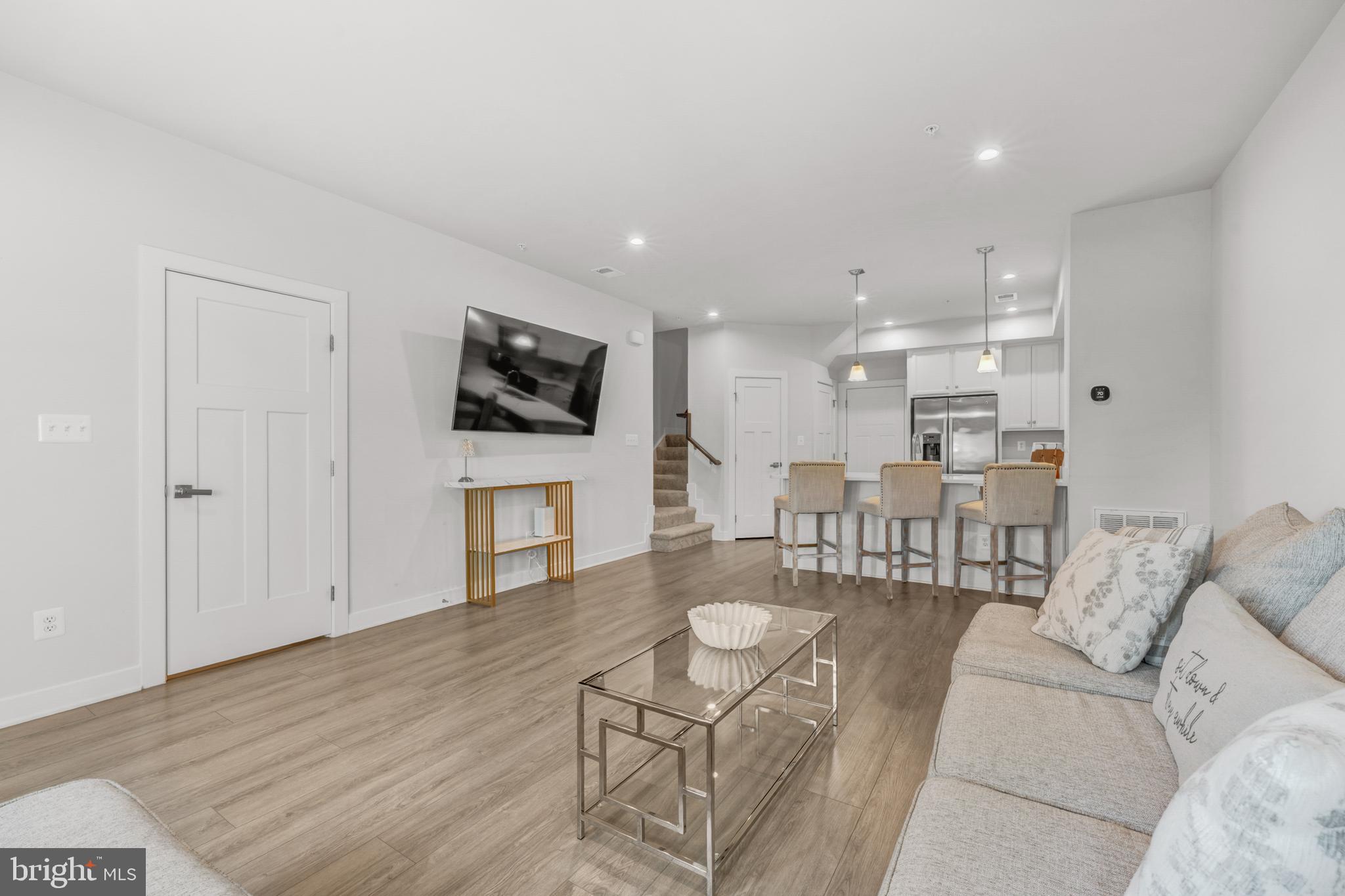 Price improved PLUS a $10,000 seller credit — use it toward closing costs or a rate buydown for real monthly savings. Move-in ready with incentives that rival new construction, minus the wait. This 3-bedroom, 2.5-bath townhouse-style condo lives larger than you'd expect: a bright, open-concept main level with wide-plank flooring and recessed lighting flows into a modern kitchen with island seating, stainless appliances, and crisp white cabinetry — a layout made for entertaining. Upstairs, the owner's suite is joined by two additional bedrooms and a full hall bath. All of it in a prime Loudoun location minutes to Dulles Landing shopping and dining, Stone Springs Hospital, and quick access to Rt. 50, Loudoun County Parkway, and Dulles International. Between the new price and the $10K credit, this is one of the strongest values in the corridor — schedule your showing today.