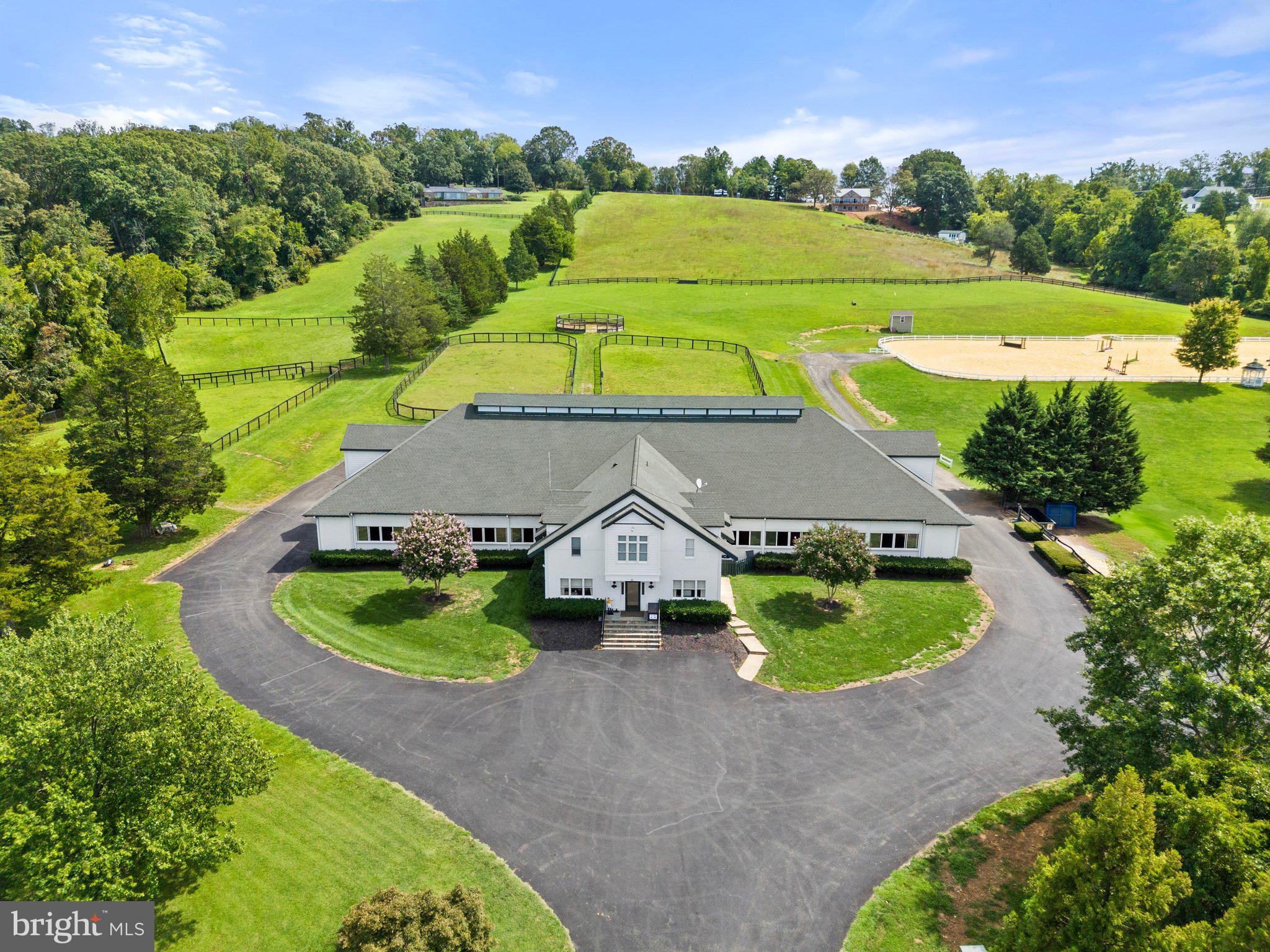 12 stall custom show barn, encircled by an enclosed shed-row to allow for exercising, with a history of great horses.  There are two heated wash/grooming stalls, 2 tack rooms share a heat pump, full loft with access to each stall, half bath, and storage closets.  There is an elegant office and large lounge arrangement with kitchen and half bath.  A two bedroom fully equipped apartment completes the barn.  There is a 150x280 show ring with new footing, a turn-out field that includes a spacious run-in shed with sliding doors for horses during inclement weather, five paddocks all with automatic waterers and a round training pen.  An invisible fence system for dogs. There is a fully enclosed, 3 bay garage/workshop with overhead gas heat (propane tank leased) and shed addition with air compressor.   Structure has 2 regular garage doors and 1 extra-large sliding door.  A bonus is a potential building site with mountain views to complete this offering.  1 mile from old town Warrenton.  Comcast.  The name EMO Stables LLC does not convey with sale.  Above ground gas, diesel tanks convey.  2 wells.  Stable roof shingles new in 2023.  All on 18 acres subject to completing boundary line adjustment.  Seller needs rent back.  in land use tax program. includes parcel 6973-97-4438.  Please no drive-ins.  Thank you.