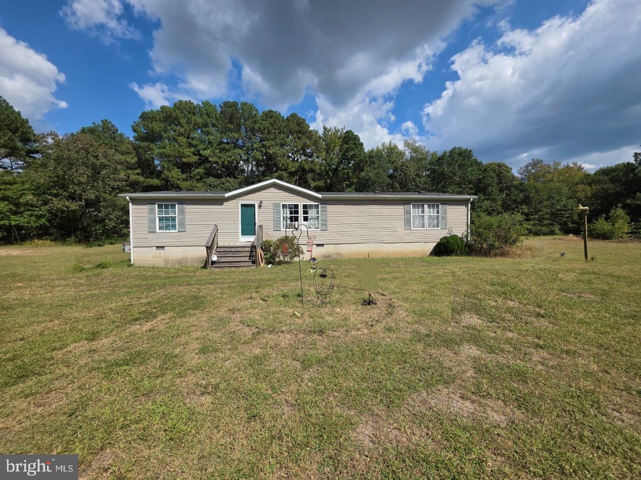 Back on the market and ready for the next buyer! What an opportunity at an incredible price. Home is situated on over 6 acres in scenic Wicomico County. Cleared areas provide space for recreation, gardening, and gatherings, while the wooded acreage offers natural seclusion and abundant wildlife. The home features a spacious layout with generous living areas and a peaceful rural setting surrounded by nature. While the property does require some updates, it provides a rare chance to customize and create your vision on a sizable parcel of land.  When you enter the home, you will find an ample living room with 2 large windows that invites natural lighting. Towards the back you will find the large kitchen, which is fully equipped and flows seamlessly into the dining area.  Here you will also find a door that leads you to the laundry room and a door that leads you to the backyard. The home offers 4 ample bedrooms with the primary suite on one side of the home and remaining 3 bedrooms  and full bath on the left wing. The house is conveniently located next to Route 50 and the west side of the county. Embrace the serenity and create your perfect retreat in this peaceful, scenic setting!