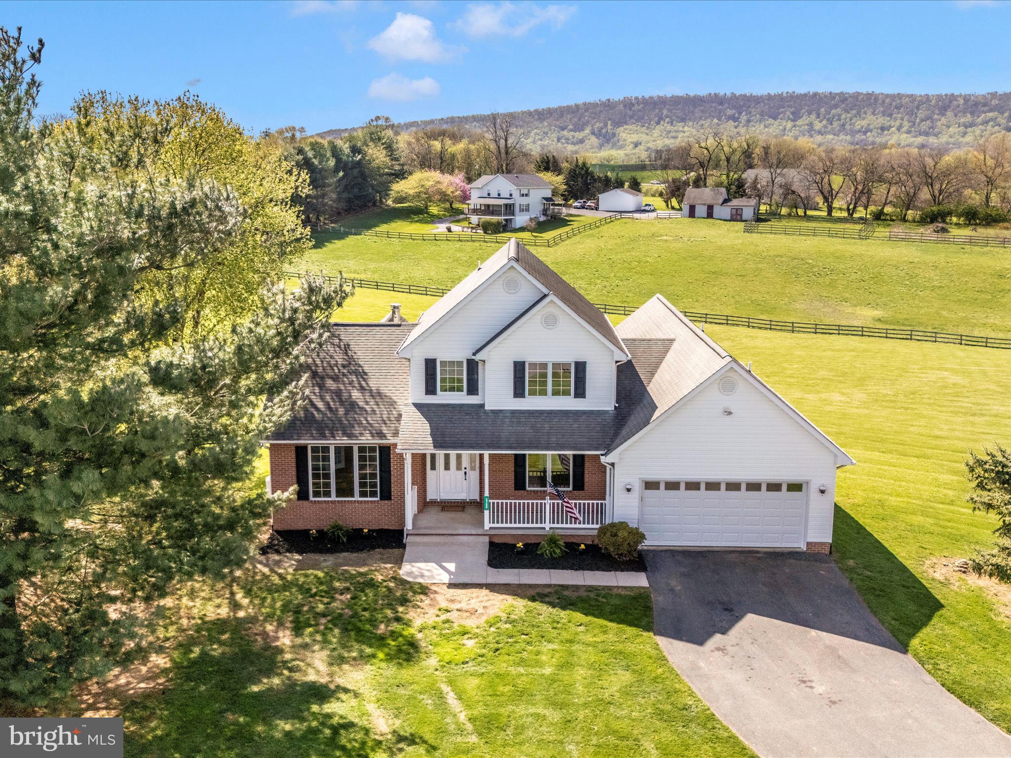 This beautiful Cape Cod has been beautifully maintained and updated.  You will love the views and the light that pours into this home from just about every room.   All new flooring, fresh paint, new granite countertops in the kitchen, new stainless steel appliances, new garage doors, new rear door in the basement, new water treatment systems, and a water heater. The roof is about 10 years old and is an architectural shingle; the furnace is newer.  Situated in a large cul-de-sac with gorgeous mountain and pastoral views, this home has over 4100 sq ft of living space, an oversized garage of 440 sq ft, and a 2.06-acre lot.  Enjoy the sunrise from the breakfast area or the spacious 19X12 ft deck, or enjoy watching the children playing in the cul-de-sac while the sunsets from the front porch.  The whole property features underground fencing for furry ones. The basement has lots of windows, a rough-in for a full bath.  Loads of room for recreation, home business, bed, bathroom, and storage! So many possibilities here!