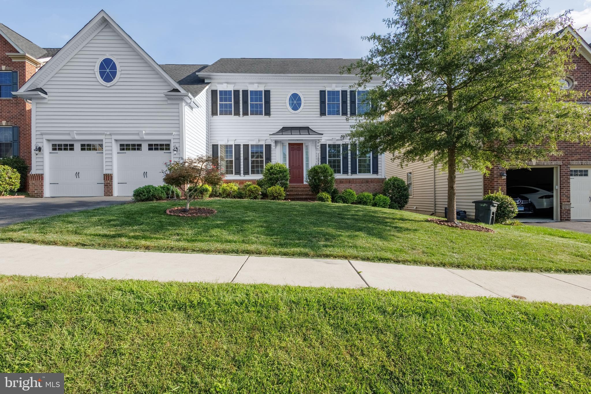Refined Living in Clarksburg Village. This thoughtfully designed home blends classic East Coast charm with modern craftsmanship, featuring a bright exterior, warm brick accents, and timeless architectural details. Built in 2017 and loaded with most available options, this stunning 6500+ sq. ft. Chapel Hill II model by NV Homes features a dramatic and open two-story family room with a coffered ceiling and gallery overlook.  The entire first floor living areas, main level bedroom, walk-in closet, and upstairs hallway have real hardwood floors throughout. The expansive chef’s gourmet kitchen includes an oversized island with granite countertops, double sink, 36" 5-burner 17,000-BTU cooktop, built-in microwave, double wall oven, 42” raised panel cabinets, a butler’s pantry, and a banquet size dining area. The main level foyer opens to the study and formal dining room, paneled in chair-rail height wainscoting. The large private study set off by double glass doors boasts beautiful natural light where it is nicely tucked away providing added privacy yet easy accessibility to family activities. The main level also incorporates a private first-floor suite with its very own full bath and walk-in closet, perfect for hosting friends, family, and multi-generational living.  A separate half bath serves guests. 10 foot ceilings and a slate surround gas fireplace grace the main level. An arrival center with built-ins off the extended 2-car garage offers convenience. Upstairs the amenities continue with spacious bedrooms, a linen closet, and a coveted second floor laundry room. Using the dual staircases to access the upper level, you will find a lavish primary suite with huge walk-in closets, a tray ceiling, a separate sitting room, and your own private balcony. You will love the luxurious primary bathroom with a soaking tub, ceramic tile shower and separate comfort height double vanities. The upper-level also includes a Jack-n-Jill bathroom between bedroom 2 and 3 with dual sinks and large closets. Bedroom 4 has its own ensuite bathroom and walk-in closet as well. Designed for comfort and efficiency, the residence features 4 separate HVAC zones. The sun-drenched lower level offers exceptional versatility — featuring an expansive recreational room with luxury vinyl plank flooring throughout, 4 full size windows, custom 6-inch baseboards, and upgraded LVP stairs with white risers, while generous unfinished storage with a full bath rough-in for a 6th bathroom offers room to expand.  Step through the double French doors to a meticulously curated outdoor retreat: a backyard fully enclosed by a low-maintenance vinyl fence, complete with a raised planting bed and complemented by ambient landscape lighting and brick edging out front.  Located within walking distance of Hallie Wells Middle School, and just minutes from shopping, dining, and Exit 16 on I-270.