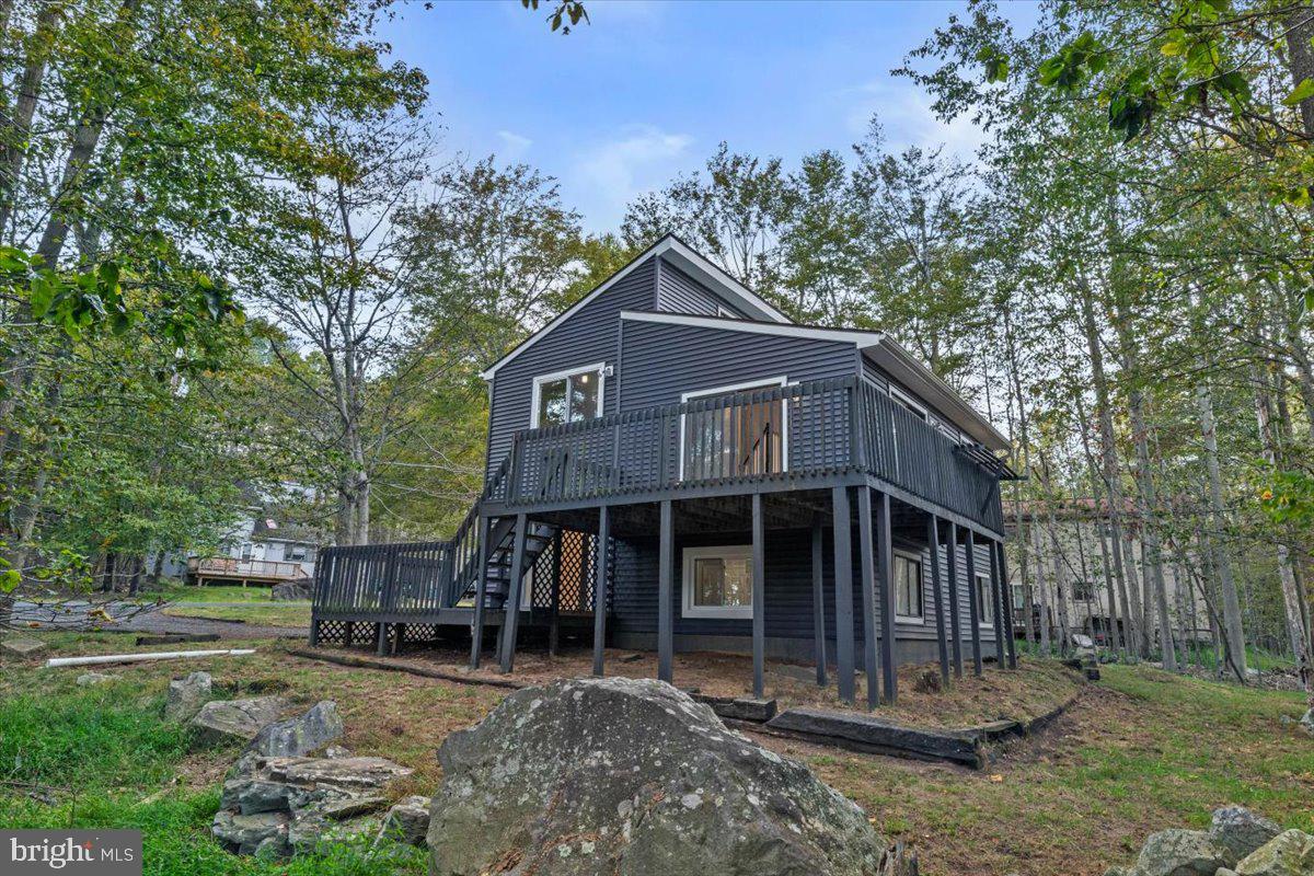 Discover this TRULY UNIQUE 4-Level, 3-Bedroom, 2-Bath Home in the sought-after gated community of A Pocono Country Place. Perfectly designed for both relaxation and entertaining, this home offers space, character, and an unbeatable location. The first level features two spacious bedrooms and a full bath. Upstairs, the second level showcases a bright and open living room with plenty of natural light. The third level includes a welcoming dining area and a fully renovated kitchen with modern upgrades. At the very top, the primary suite offers total privacy with its own full bath and walk-in closets. Enjoy the outdoors on two expansive decks, perfect for gatherings or quiet evenings surrounded by nature. Best of all, the home is just a 300-foot walk to the nearest community beach, making lake life a part of your everyday routine. Community Amenities Include: Multiple lakes for boating, fishing & swimming. Beaches & picnic areas. Indoor & outdoor swimming pools. Clubhouse with events & recreation. Tennis, basketball & sports courts. 24-hour gated security. Whether as a full-time residence, weekend getaway, or investment property, this rare 4-level home offers the best of Pocono living.