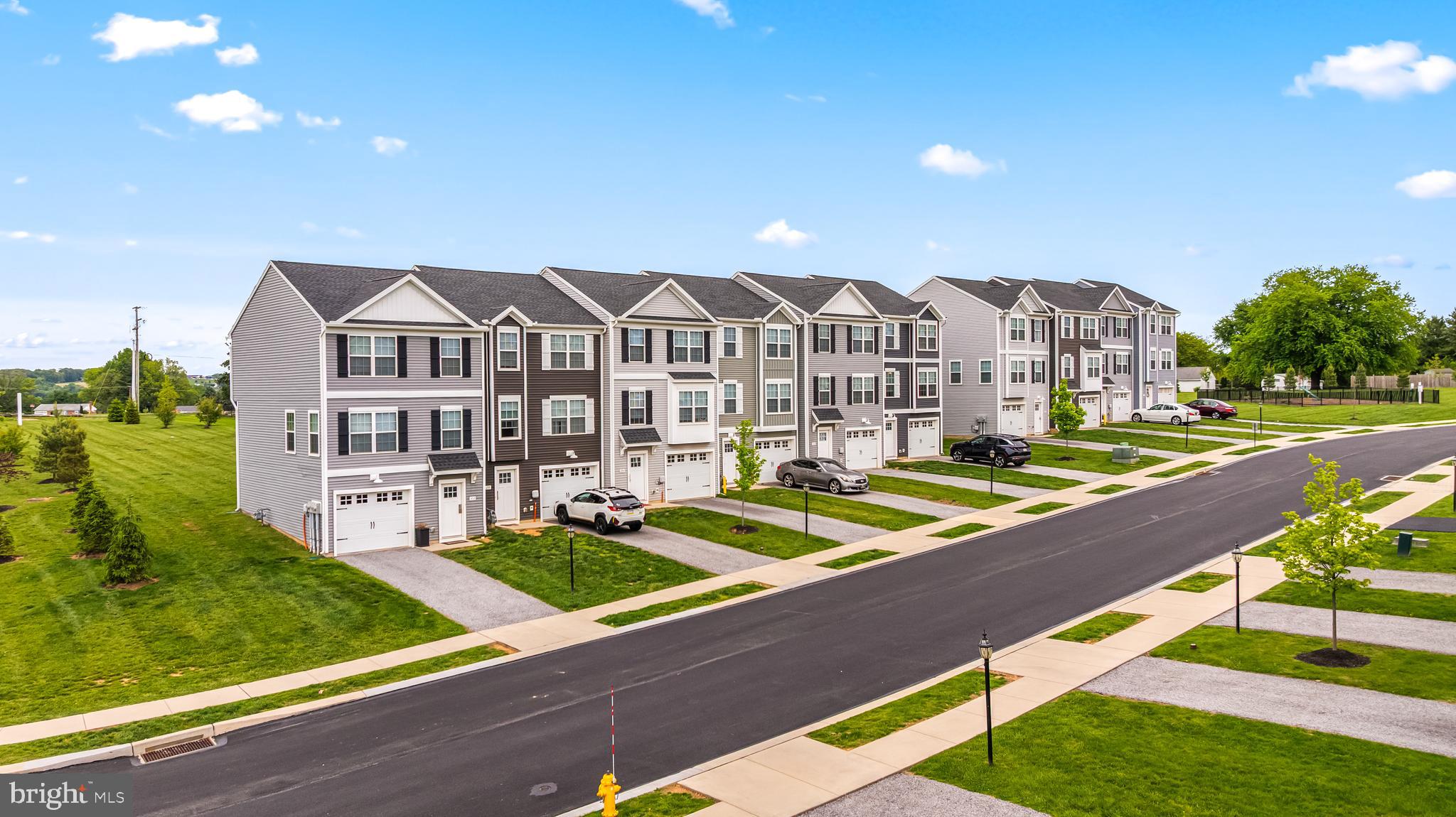 $5,000 in incentives* Welcome home to 440 Bradford Dr in Red Lion PA! Located in the Hudson Ridge community within the Dallastown Area School District, this newly constructed interior townhome offers approximately 1,900 square feet of modern living space with quick move-in opportunities available, as well as additional to-be-built options. Designed with a bright, open layout and 9+ foot ceilings throughout, this 4 bedroom, 3.5 bath home combines functionality, natural light and contemporary finishes in a convenient location. The main living level features an open floor plan connecting the kitchen, dining and living areas. The kitchen is equipped with granite countertops, an island, built-in range and microwave, stainless steel appliances including a dishwasher, and upgraded lighting fixtures throughout the kitchen and dining space. Sliding glass doors off the dining area provide access to an optional rear deck, while a conveniently located half bath completes the level. Luxury vinyl plank flooring runs throughout the first and second floors, enhancing the clean and modern design. Upstairs, the spacious primary suite features cathedral ceilings, ceiling fan, large walk-in closet and a private bath with a walk-in shower. Two additional bedrooms with carpet flooring and a shared full bath complete the third floor. The entry level includes a fourth bedroom with an attached full bath, offering flexibility for guests, office space or multigenerational living, along with interior access to the attached one-car garage. Conveniently located near Route 24, Route 74 and I-83, with easy access to York, Baltimore, Red Lion and surrounding commuter areas. Close to shopping, dining and everyday conveniences while offering low-maintenance new construction living. Schedule your private tour today!