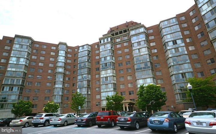 Buyer pays no condo fees through December 2026, as the seller will cover all monthly fees during this period—an exceptional financial advantage for the next owner. *The roof is currently being replaced, expected completion September, 2026.
This spacious and beautifully maintained residence is the highly desirable Model K and offers approximately 1,490 square feet with 2 bedrooms, 2 full bathrooms, and a versatile den/office, making it ideal for the discerning buyer seeking both comfort and flexibility. The generous open-concept living and dining area provides an ideal setting for both entertaining and relaxed daily living. The large table-space kitchen is both functional and convenient, with an in-unit washer and dryer for everyday ease. The primary suite includes a walk-in closet plus an additional closet, along with a spacious bath featuring both a tub/shower combination and a separate walk-in shower. The interior is filled with abundant natural light throughout the day, creating a bright and airy atmosphere that complements the open floor plan and makes the home feel even more spacious and inviting.
This home also includes a large enclosed lanai/sunroom with floor-to-ceiling windows that extends the living space and provides a light-filled retreat that can be enjoyed year-round, enhancing the overall sense of openness and comfort.
Located in Vantage Point East within Leisure World Maryland, the bright, open layout with engineered hardwood flooring throughout and tasteful, cohesive finishes makes this the perfect home!

Recent updates include a new HVAC system, kitchen appliances less than 3 years old, and flooring approximately 5 years old, adding value and peace of mind for the next owner.

Additional features include garage parking space #20 and a separate storage unit #8, providing valuable convenience and extra storage capacity.