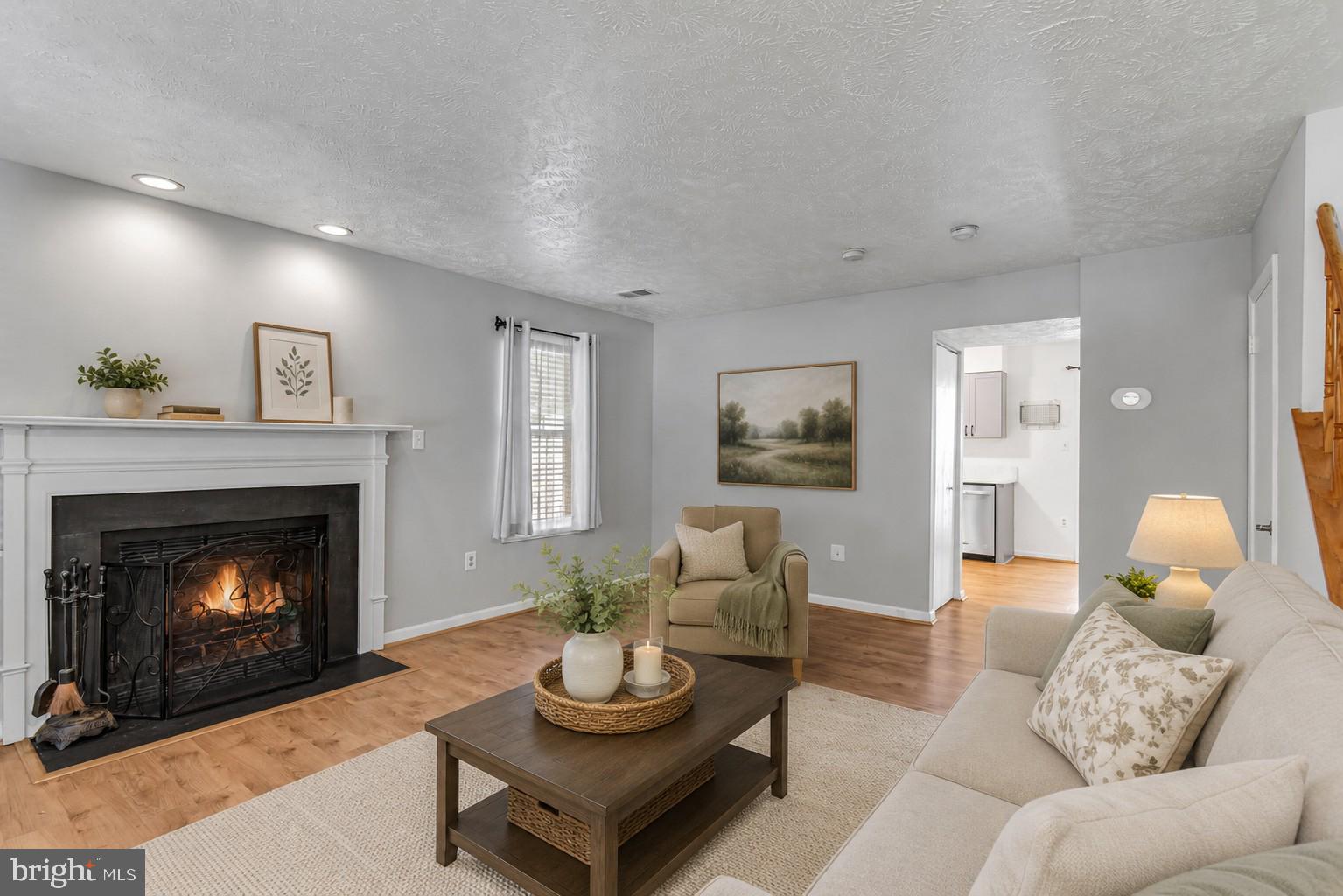 This beautifully renovated end unit townhome is nestled on a premium corner lot in a quiet cul-de-sac surrounded by treed common area for ultimate privacy.  Featuring 2 bedrooms and 2 full baths, this home boasts warm luxury vinyl plank flooring on the entire main level, soft neutral paint throughout, updated lighting, and a renovated kitchen and renovated baths creating instant move in appeal. An open foyer welcomes you into a spacious living room with a bay window and a cozy woodburning fireplace. The updated kitchen has gorgeous quartz countertops, a farmhouse sink, soft close cabinetry, and stainless-steel appliances. The adjoining dining area has sliding glass doors opening to a new Trex deck and large level yard with shed surrounded by privacy fencing, ideal for indoor and outdoor dining and relaxation. A full-sized stackable washer and dryer (2019) is also located on the main level. Upstairs you’ll find two spacious bedrooms, each with lighted ceiling fans and large closets. The primary suite boasts an ensuite bath with a new walk-in shower with marble style tile and stylish sliding glass doors. The chic hall bath has also been updated.  Other updates include upgraded attic insulation and access stairs (2016). Two assigned parking spaces add convenience. Enjoy the community amenities, basketball, tennis and pickleball counts, playground and common grounds. The location can’t be beaten - near Fort Belvoir with easy access to I-95, I-495, I-395, Route 1, and Telegraph Road. It is walkable to the VRE Lorton Station and the commuter bus to Franconia-Springfield Metro. Nearby conveniences include Wegmans, Lorton Station Town Center shops, medical offices, and restaurants. Local attractions include charming Old Town Occoquan and an abundance regional and state parklands. Beginning photos are virtually staged.  Qualified buyers may be eligible for Zero Mortgage Closing Costs, potentially saving thousands at closing. Contact listing agent for details!