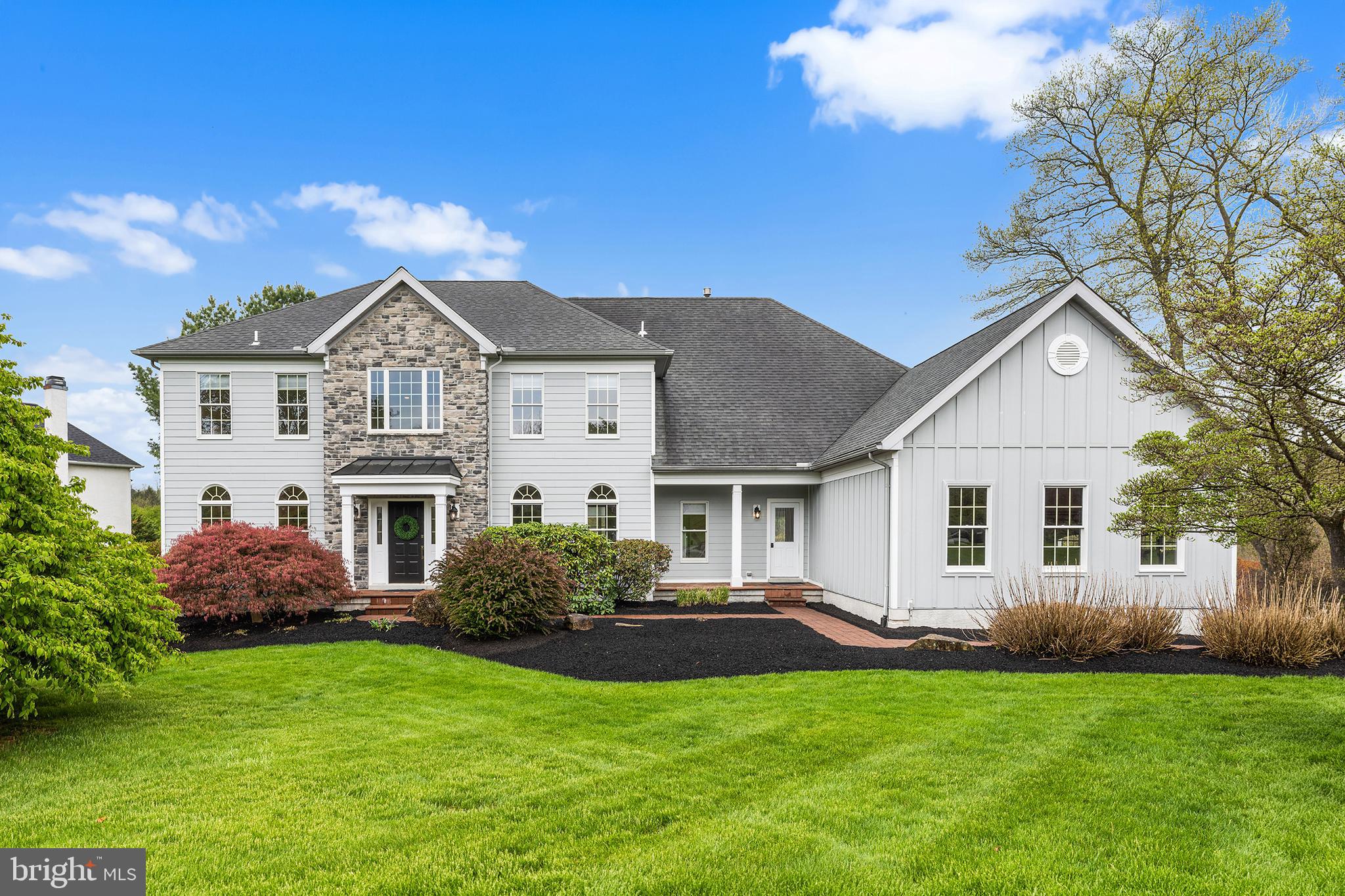 Rare five-bedroom luxury residence nestled within the prestigious Marshallton Chase neighborhood of West Chester, Chester County, 327 Twin Pond Drive is a singular offering where luxury, craftsmanship, and effortless livability converge on a premier one-acre lot. Over $300,000 in designer-curated improvements have transformed this move-in ready masterpiece into a showpiece, from the striking Hardie-board and stone accent exterior to the impeccably appointed interiors within. A sweeping driveway with an oversized three-car garage and lush professional landscaping announce the home's arrival. Step through the front door into a soaring two-story foyer crowned by a designer chandelier, where the open, flowing floor plan unfolds with nine-foot ceilings, rich refinished hardwood floors, and custom millwork at every turn. The formal living and dining rooms exude timeless sophistication, each adorned with refined wainscoting and bathed in light through dual arched windows, the dining room crowned with rich Sanderson wallpaper. The great room is nothing short of breathtaking, anchored by a dramatic floor-to-ceiling whitewashed stone fireplace with a hand-crafted mantle, flooded with natural light, and finished with designer lighting, and Thibaut drapery. It flows effortlessly into the sun-drenched sunroom and on into the chef's kitchen, where travertine flooring, Brazilian stone countertops, an oversized island, a Bedrosians artisan backsplash, and a generous pantry create a space that is as beautiful as it is functional. A private office, renovated powder room and a mudroom outfitted with California Closets cabinetry complete the main level with style and practicality. Upstairs, four spacious en-suite bedrooms offer unmatched comfort and privacy, while the primary suite is simply extraordinary, a tranquil sitting room, dual walk-in closets, and a completely reimagined spa bathroom by Rudloff Custom Builders featuring a walk-in shower, soaking tub, separate toilet room, and dual vanities that frame the space in understated elegance. The fully finished walkout basement, with impressive nine-foot ceilings, delivers the fifth bedroom and takes entertaining to an entirely new level: two expansive gathering spaces, a home theater area, a kitchenette with bar-height counter, full-size refrigerator, sink and stove, a dedicated home gym with premium flooring and plenty of room for equipment, a gas fireplace, and a full bathroom, all with direct walk-out access to the rear yard. Outside, a Trex deck overlooks a serene and private one-acre backdrop with an in-ground sprinkler system keeping the grounds immaculate, and endless possibilities to create the outdoor living space of your dreams. Nature lovers will appreciate the proximity to the Stroud Preserve, offering trails and open space just moments from your door. Award-winning West Chester Schools. And when you're ready to venture out, vibrant downtown West Chester is just minutes away, offering an exceptional dining scene, boutique shopping, live music, and the charm of one of Pennsylvania's most beloved boroughs right at your doorstep. Every upgrade. Every detail. Truly move-in ready, nothing left to do but arrive and live beautifully.