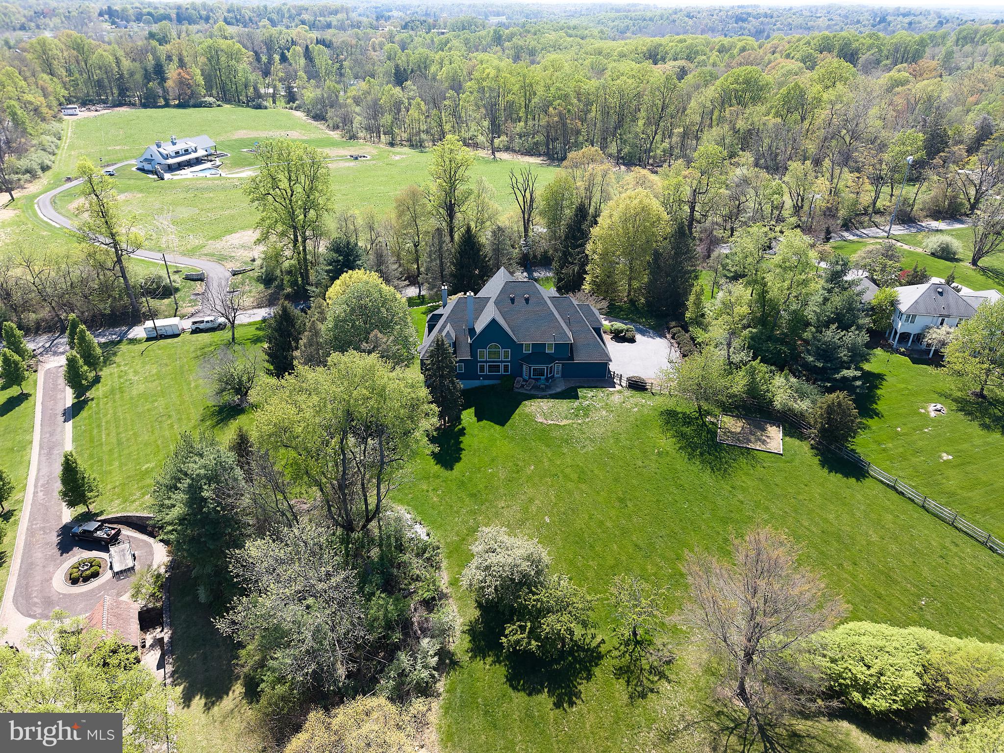 A rare offering in the heart of Chester Springs- just minutes from major roads and highways- this exceptional estate home blends privacy, elegance, and everyday flexibility. Set behind a gated driveway, the approach alone sets the tone for something truly special.  Perfectly positioned on a beautiful two acre homesite, the backyard offers and ideal setting for recreation, entertaining, or simple enjoying the peaceful surroundings and captivating views .  This impressive 6 bedroom home offers a thoughtful blend of timeless design, generous living spaces, and refined finishes throughout. Set on a picturesque lot , the property provides both privacy and convenience.  Hardwood floors extend through much of the home, complemented by detailed millwork and well-designed living spaces. The expansive kitchen features stainless steel appliances, wine refrigeration, solid wood cabinetry, quartzite countertops and a large walk-in pantry. Ample space and casual dining areas make the kitchen both functional and inviting. The main-level primary suite offers a private retreat with two walk in closets and a spacious ensuite bath.  An adjoining office with custom built ins and a gas fireplace provides flexible space for work and relaxation. Upstairs, five bedrooms offer flexible living arrangements, including a private guest or au pair suite, two bedrooms with ensuite baths and a Jack and Jill bath connecting the additional two rooms.  The exterior features usable grounds with open views, offering space for outdoor living and recreation. the 4-car garage provides parking and storage. This extraordinary property located in the Downingtown East School District with easy access to Routes 401 and 202, this home offers a combination of space, setting, and accessibility. Elegant, expansive, and ideally located- this is a home where luxury meets lifestyle in one of Chester Springs most desirable settings.