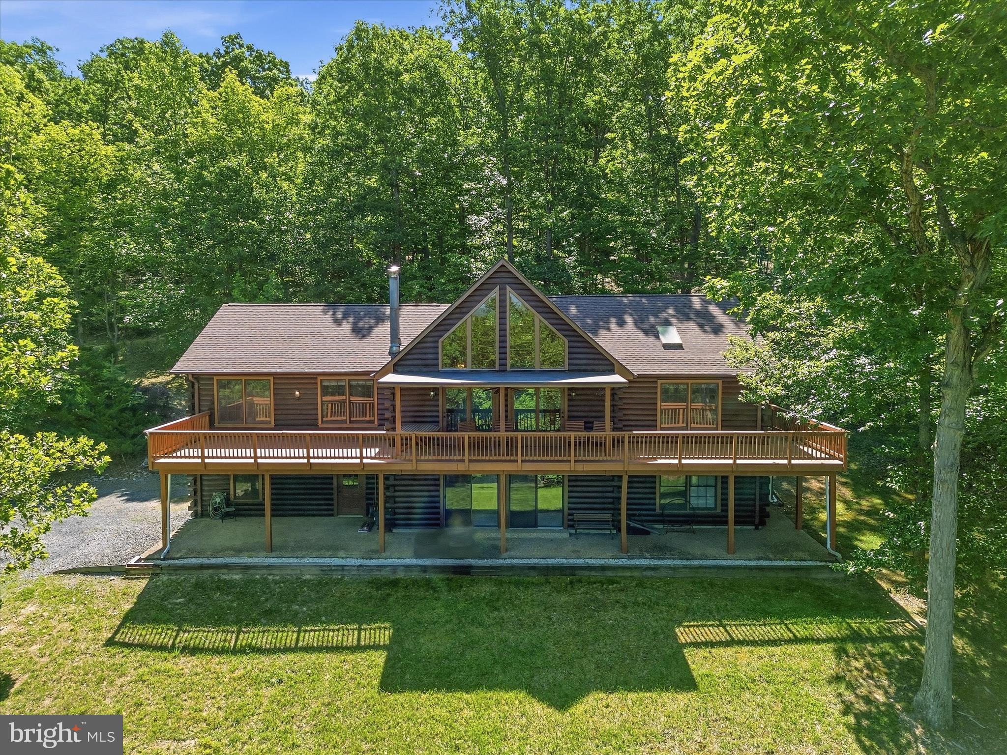 Experience Private Mountain living at its finest on partially cleared 5 acres!! This 3 bed, 3 bath Chalet offers the perfect blend of warmth, and space with its open- concept layout flooded with natural light. Overlooking the living room is the loft   ideal for an office, library or den. Primary suite includes his and hers walk-in closets, access to the wrap around deck, and primary bath with jetted tub, and separate shower.  The inviting living room features Cathedral wood ceilings, a beautiful stone backed wood stove for those chilly evenings, and access to the expansive wrap around deck. The basement family room has a secondary wood stove for those same chilly nights just off the 2-car garage with access to the covered patio with extra room to grow and use your imagination to turn into the home of your dreams.  Located in a natural setting perfect place to unwind and reconnect with nature still within minutes to town without the traffic.